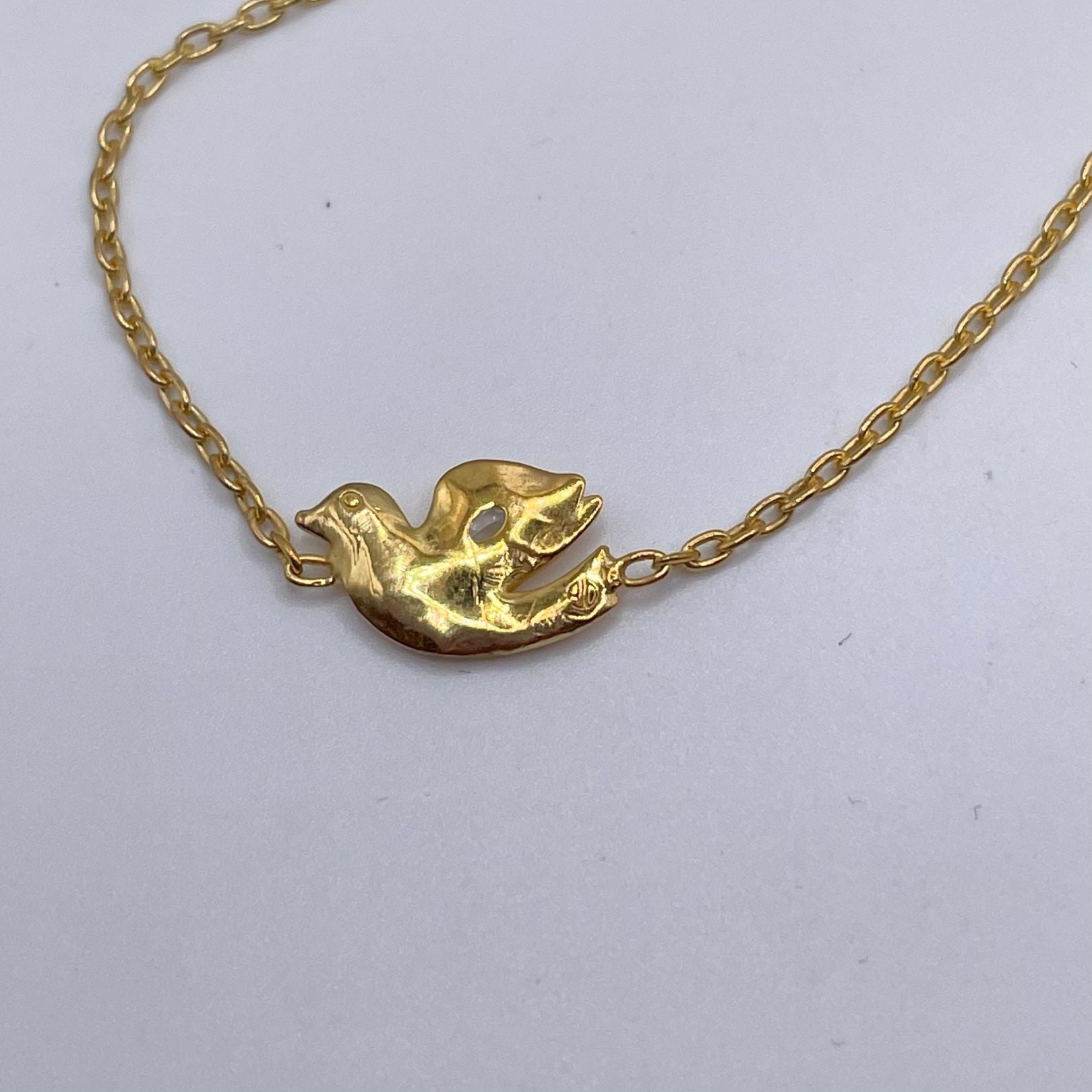 Back of 18k gold vermeil with white topaz dove bracelet by Amy Delson