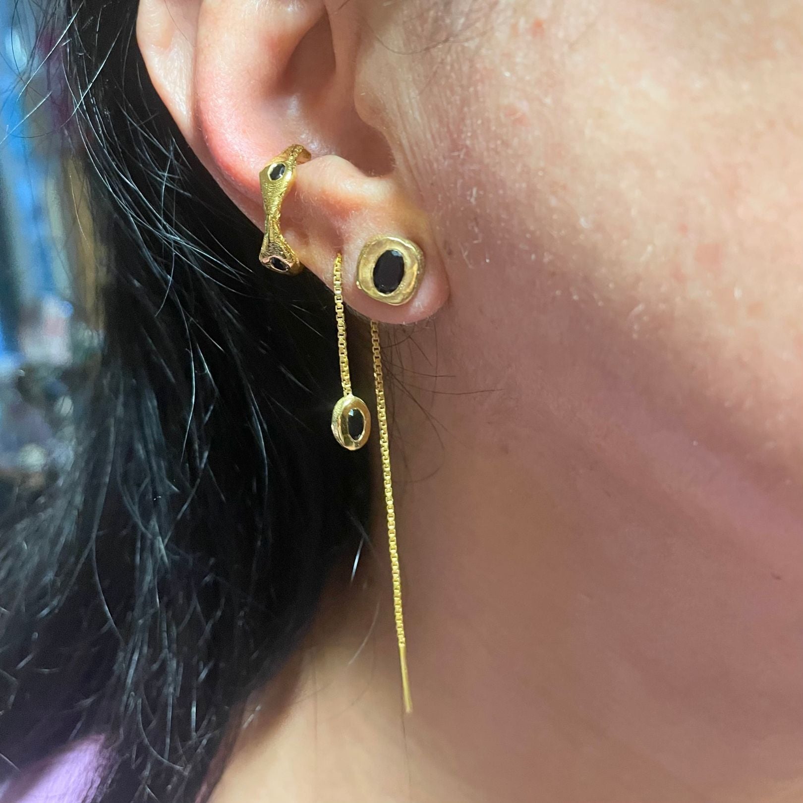 Black onyx gold vermeil earring trio on ear by Amy Delson