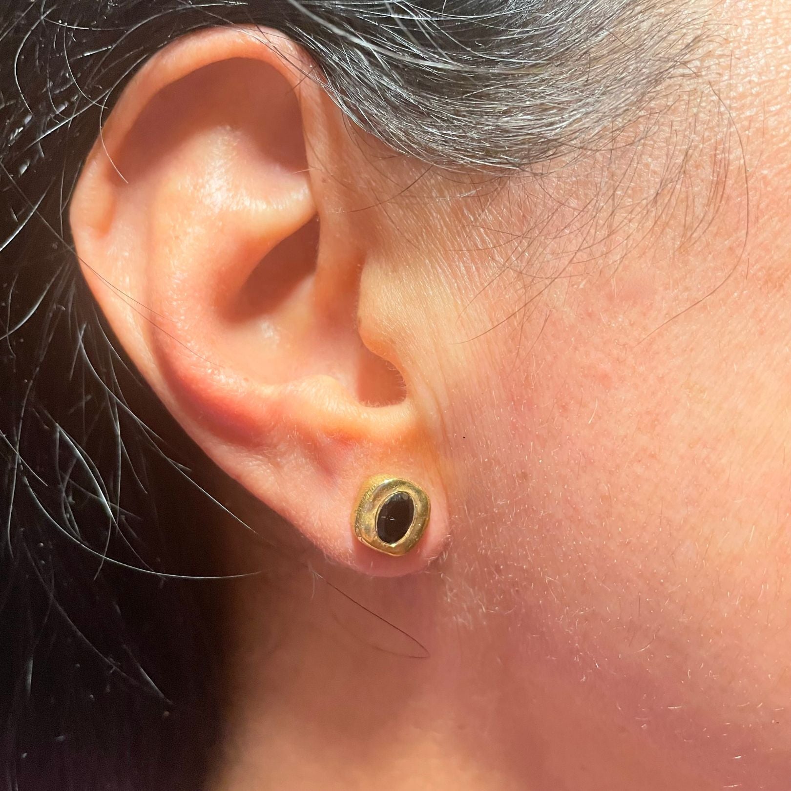 Black onyx gold vermeil stud earring by Amy Delson on ear