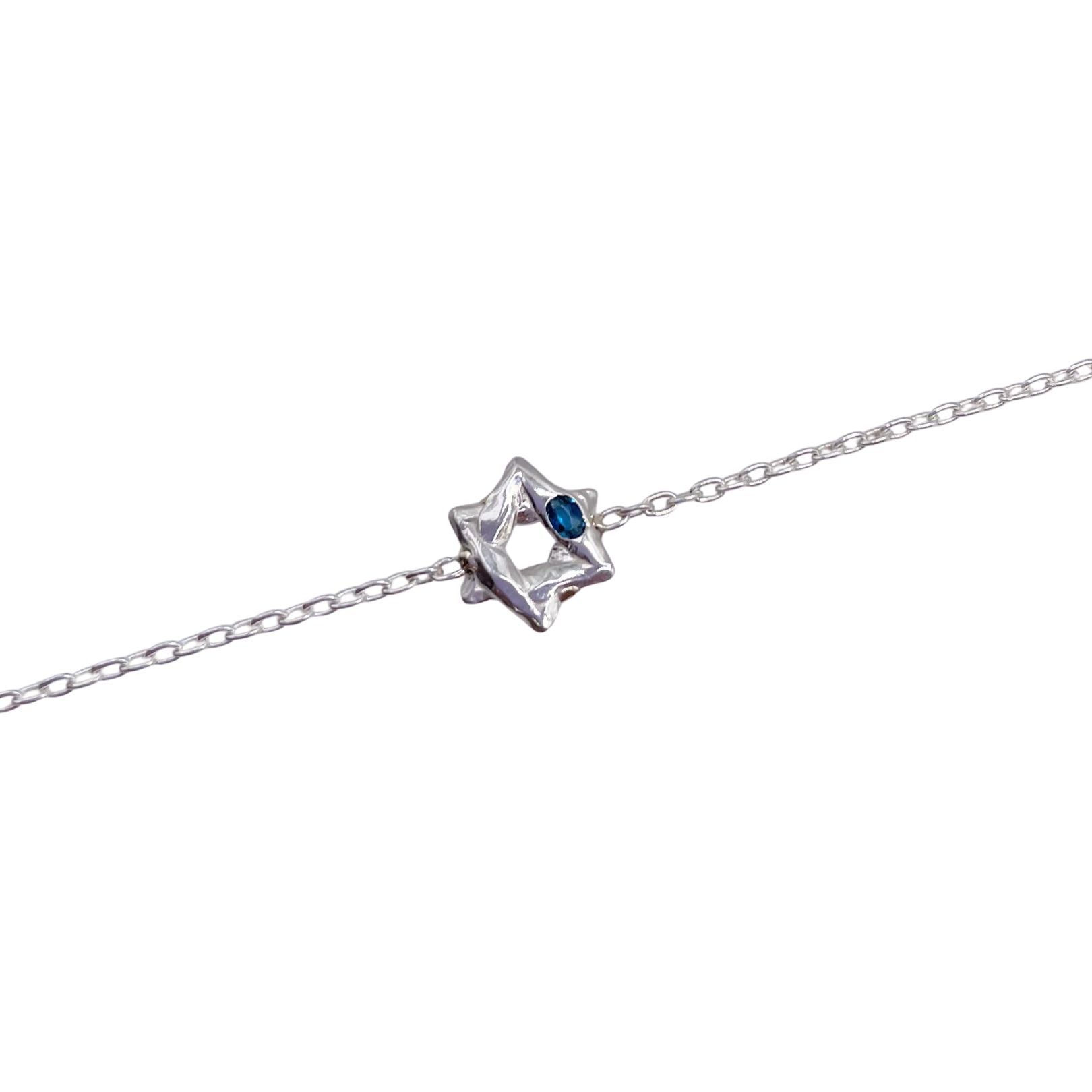 Closeup of Sterling silver Star of David bracelet with London blue topaz by Amy Delson