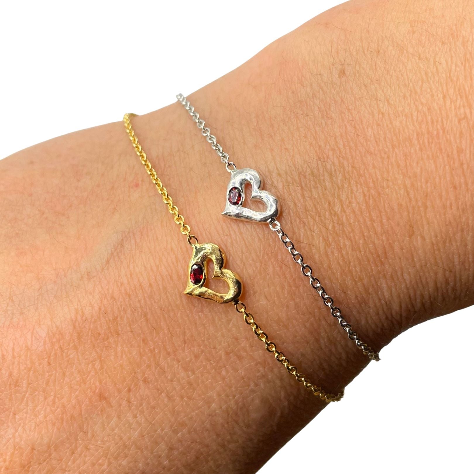 Gold and Silver with garnet heart bracelet by Amy Delson shown on the wrist