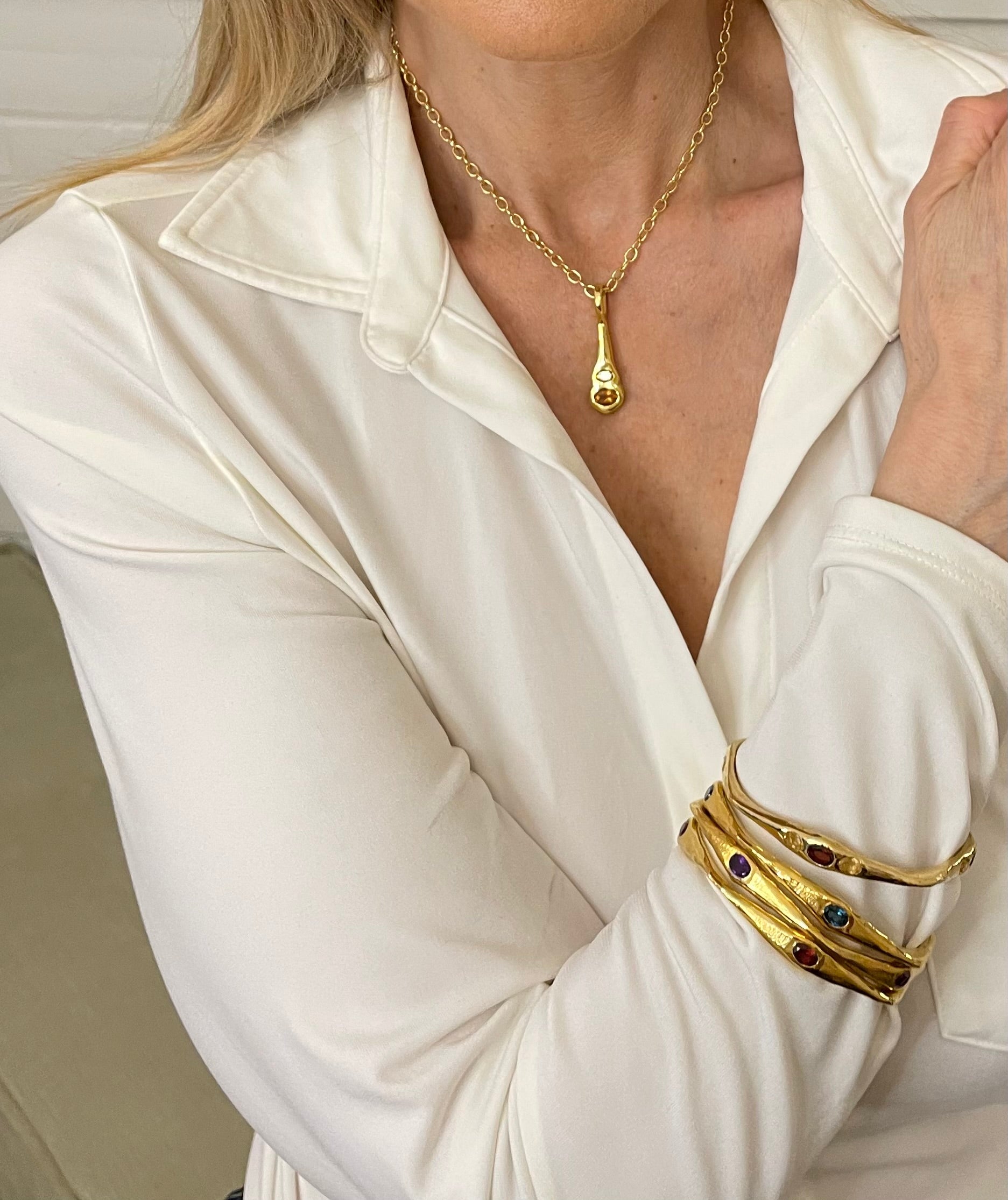 Bangle Bracelets and pendant necklace with gemstones shown on model