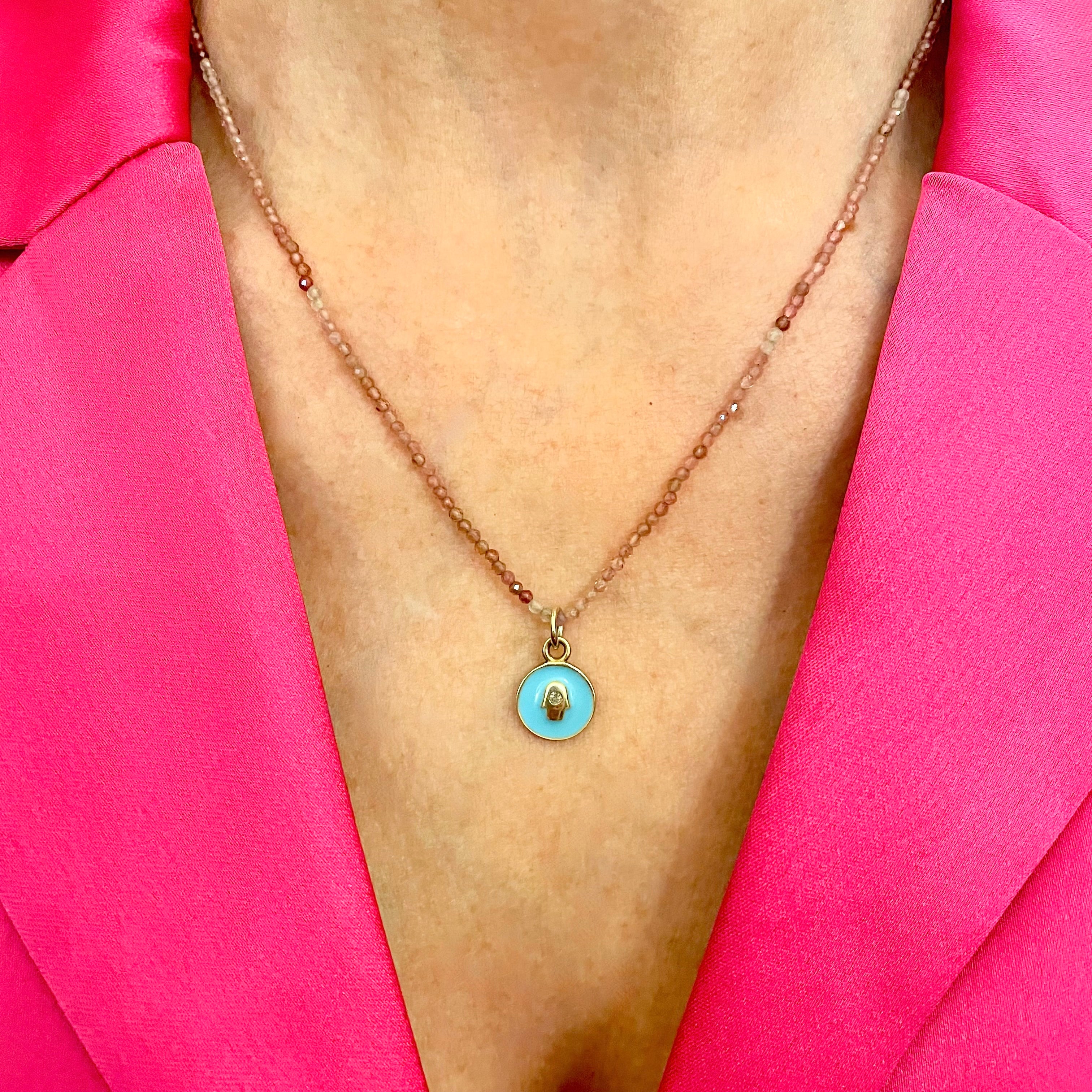 Pink tourmaline hamsa necklace by Amy Delson
