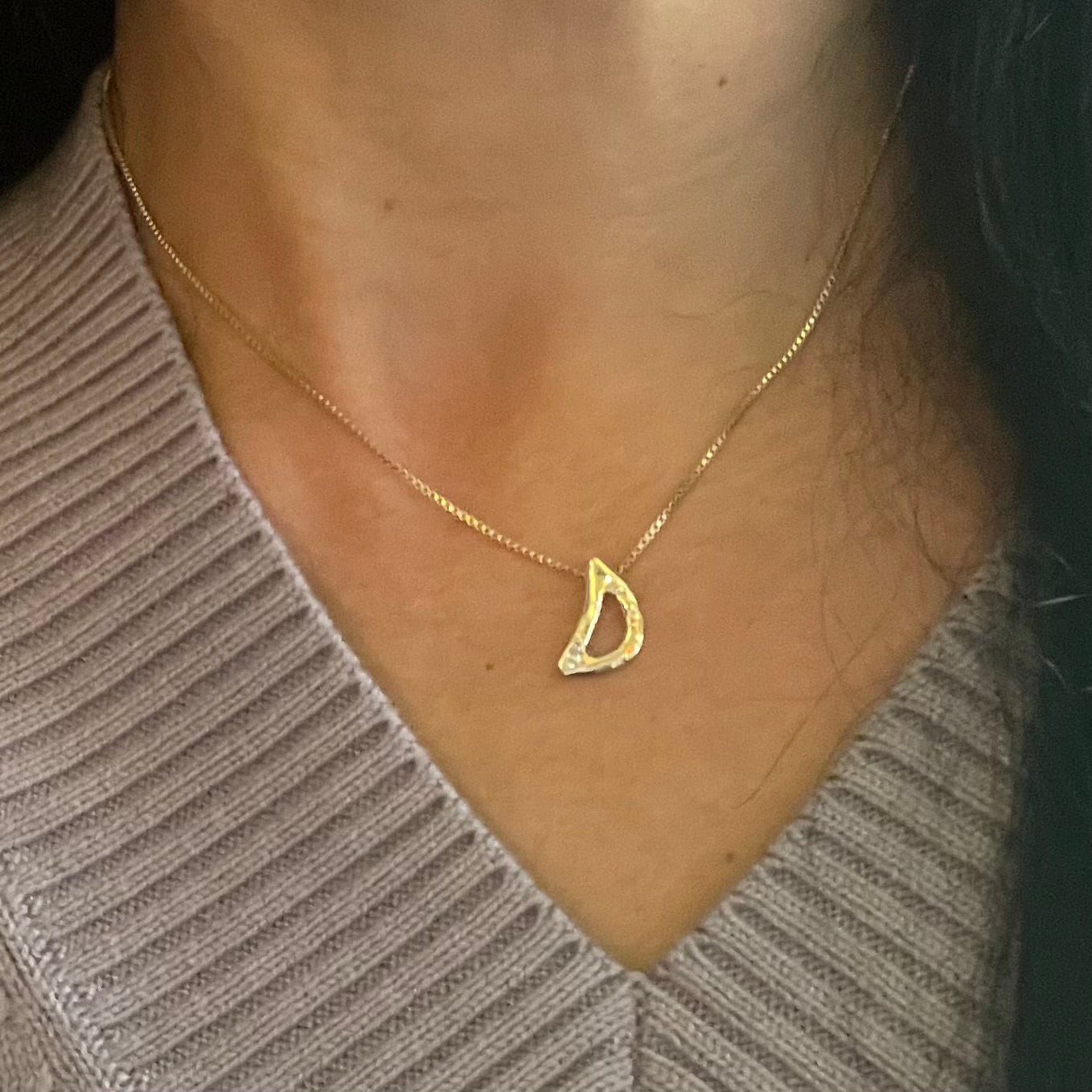 Gold Letter D by Amy Delson shown on a Model