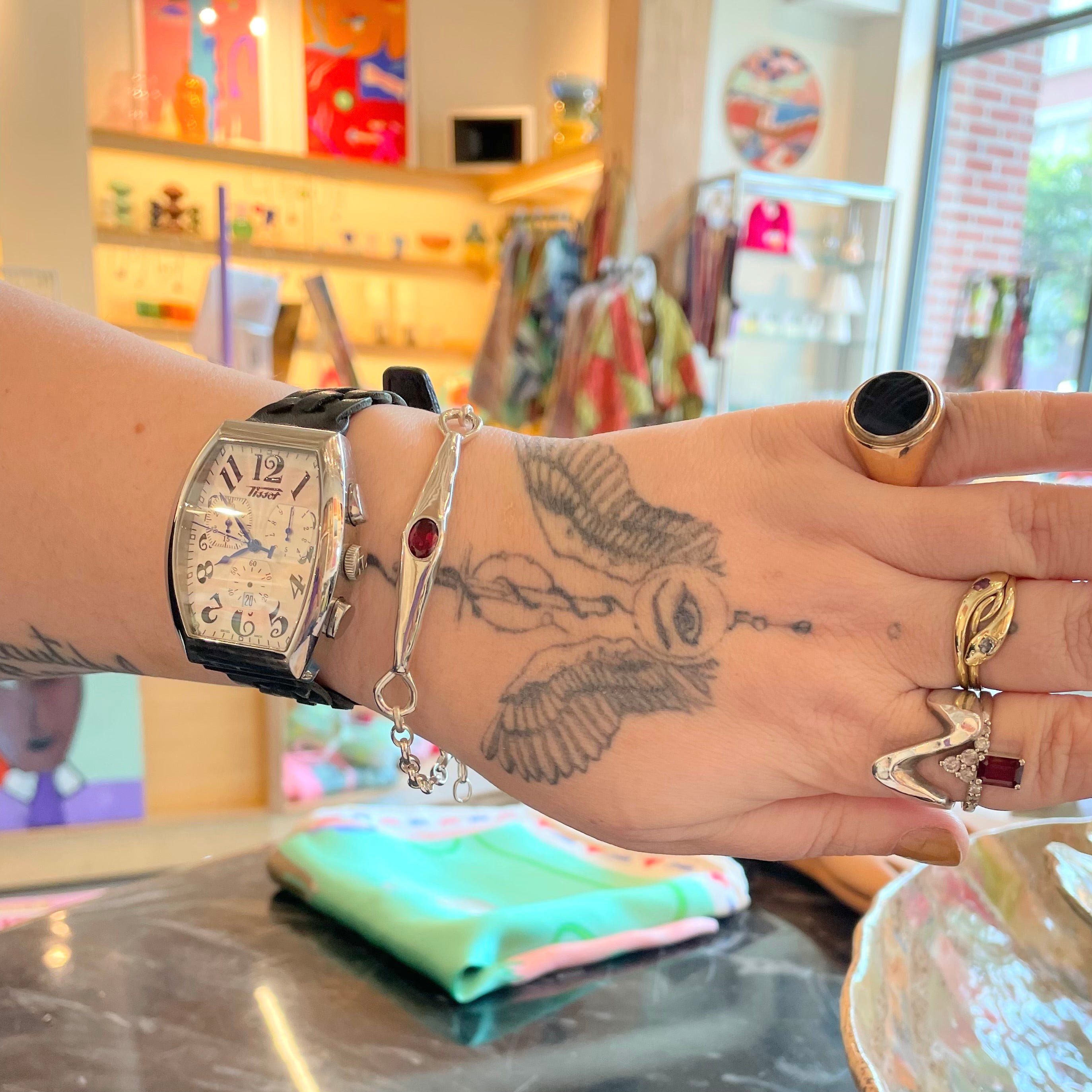 shown on a wrist, Amy Delson garnet silver bracelet