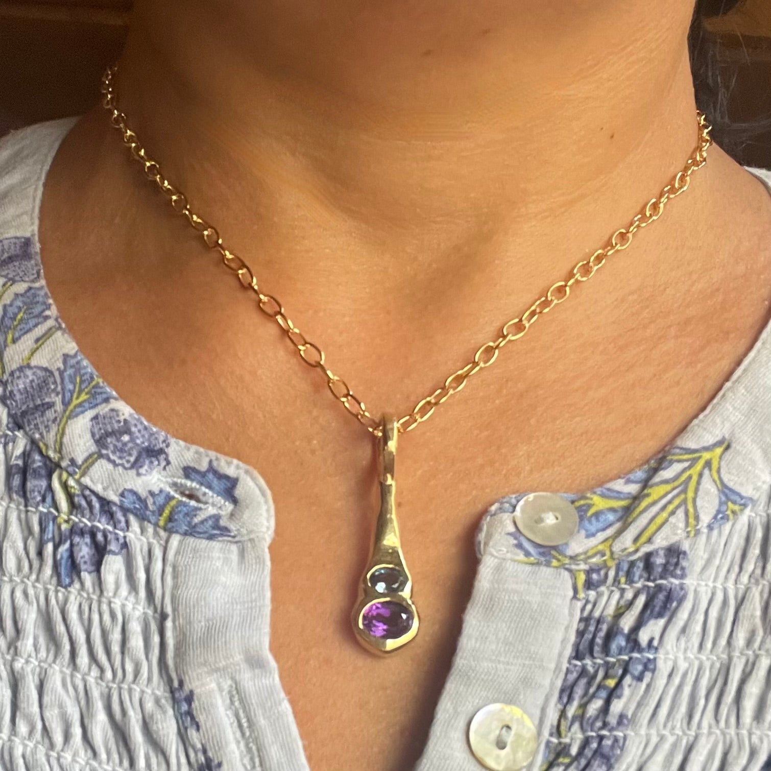 Amy Delson Blue Topaz Amethyst Necklace in Gold on neck.