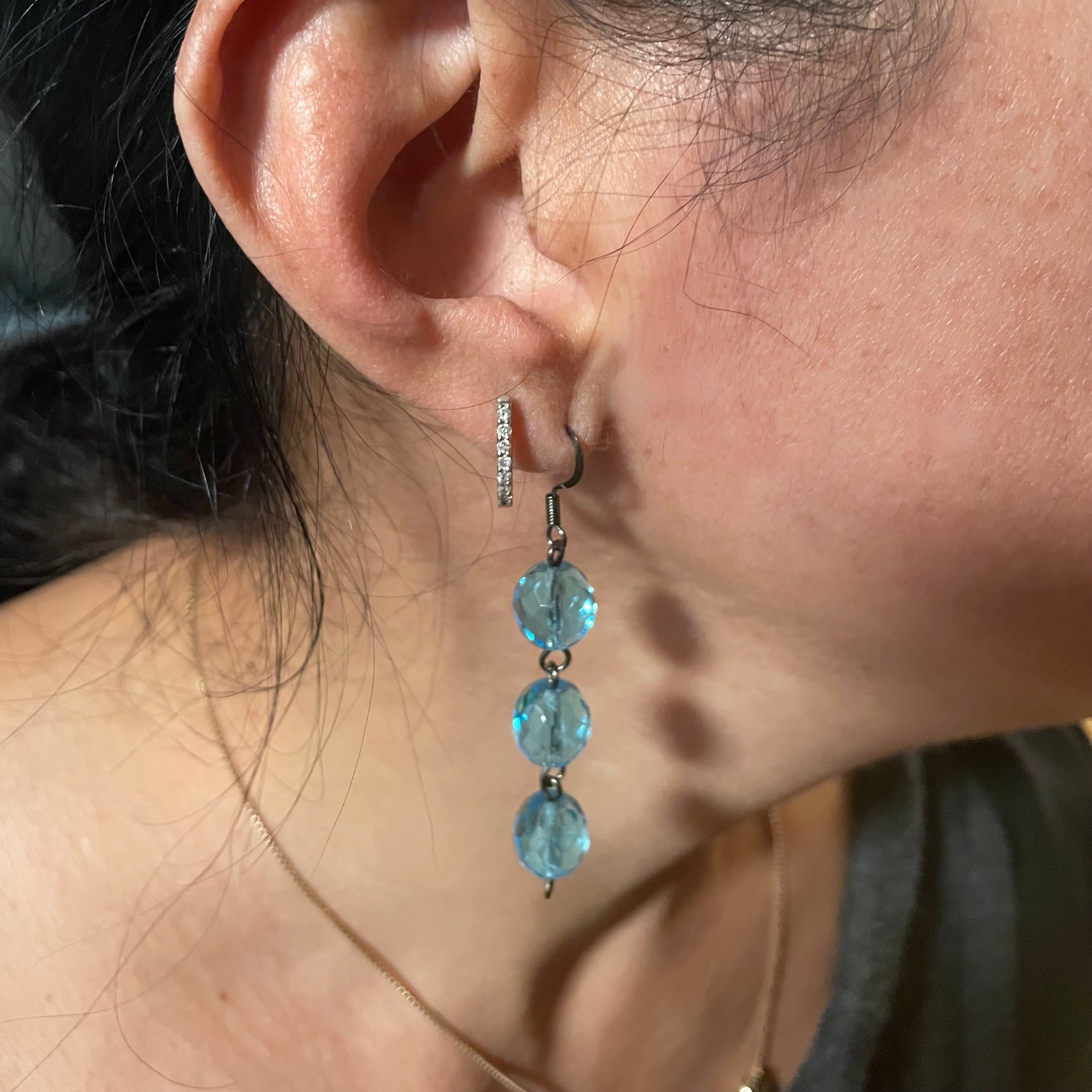 blue crystal earrings on ear
