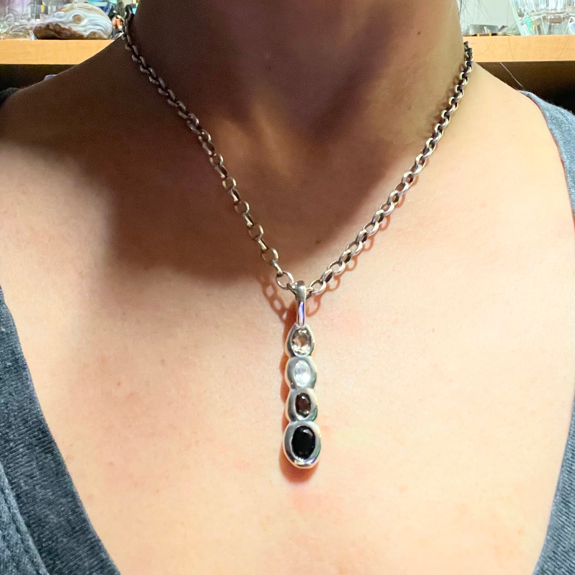 Model wears Sterling Silver onyx, white topaz, smoky quartz necklace by Amy Delson