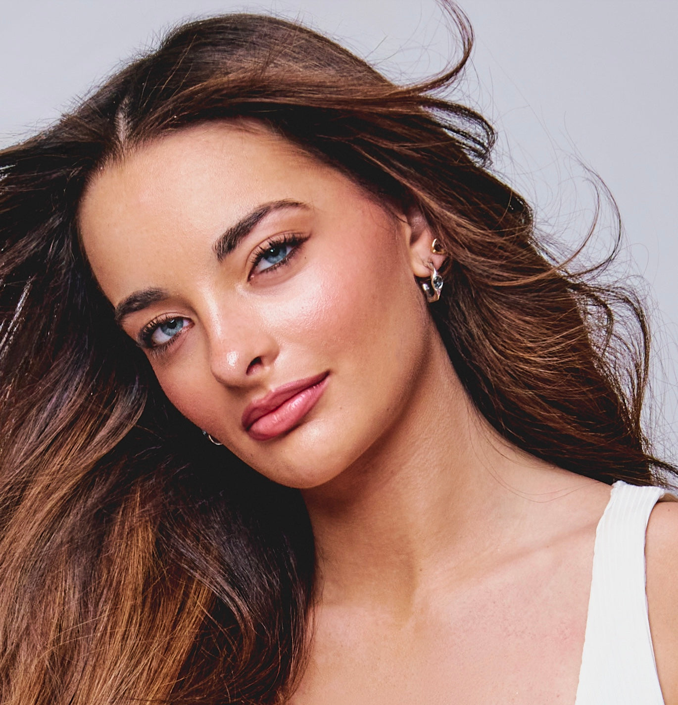Model wears Harlow Hoop and Stella Stud earrings by Amy Delson