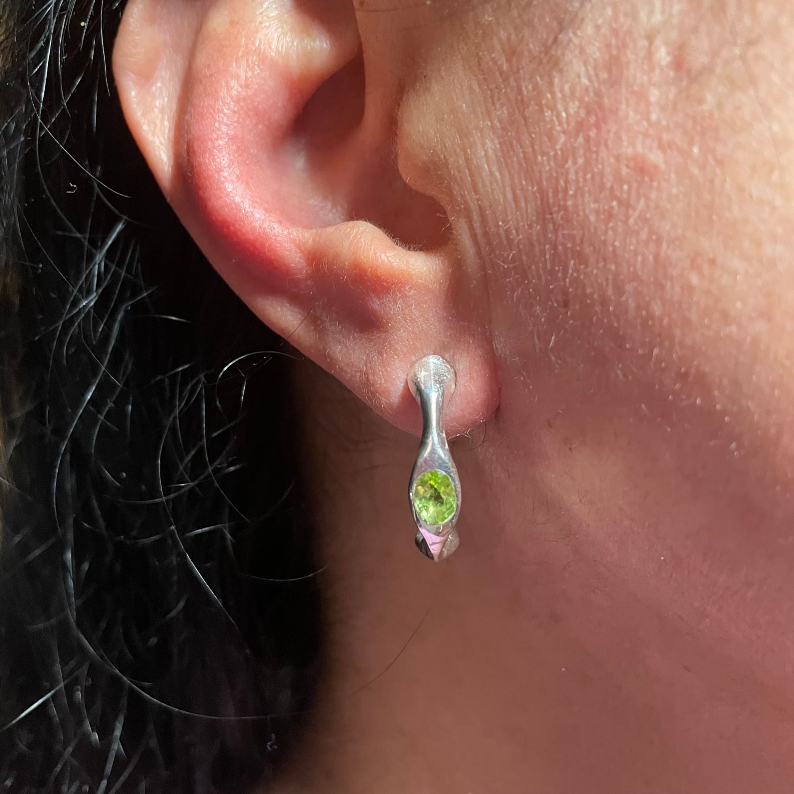 On ear, Sterling silver green peridot hoop earrings by Amy Delson