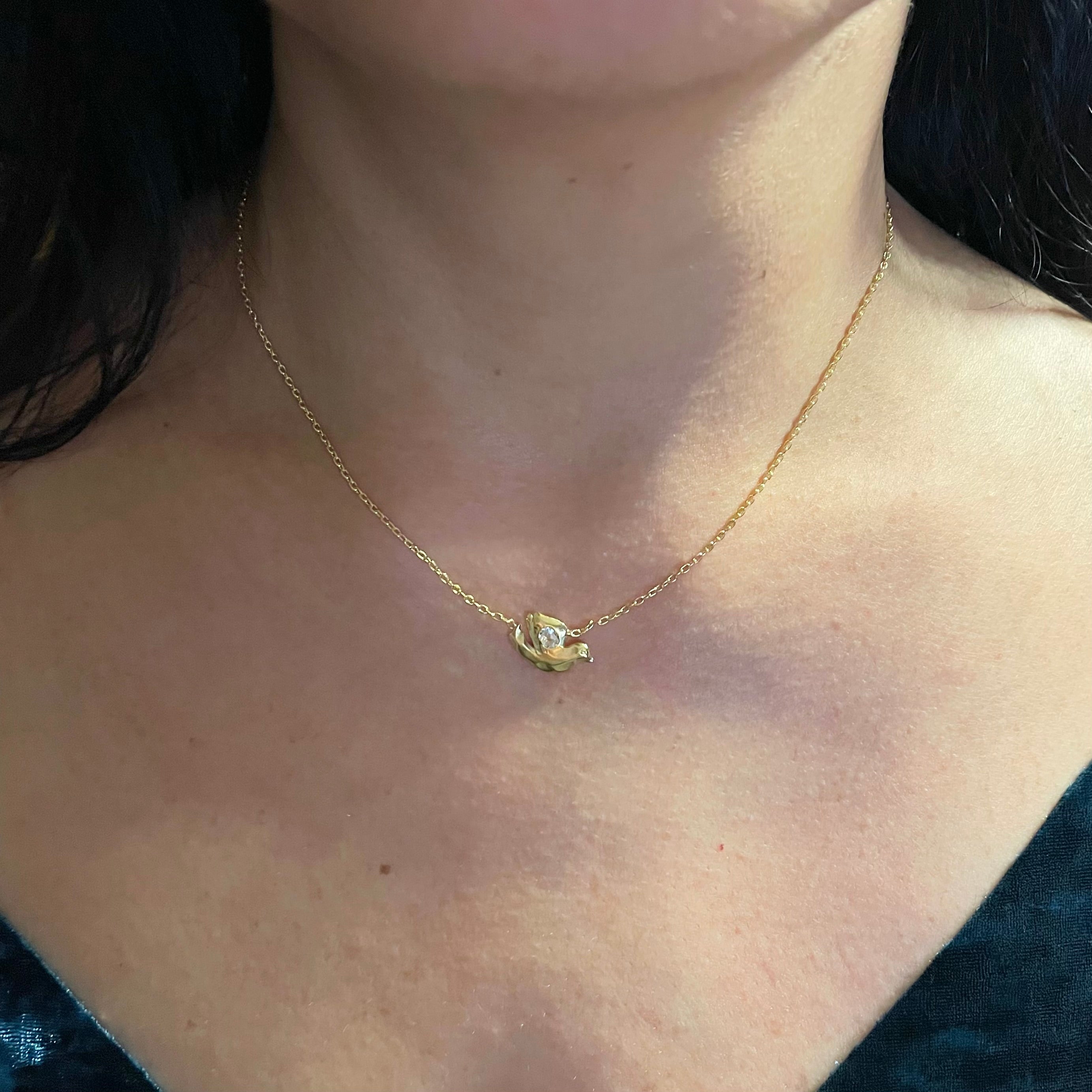 On neck: 18k Gold Vermeil with White Topaz Dove necklace by Amy Delson