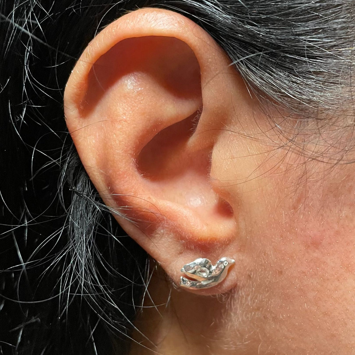 Silver white topaz dove stud on ear by Amy Delson