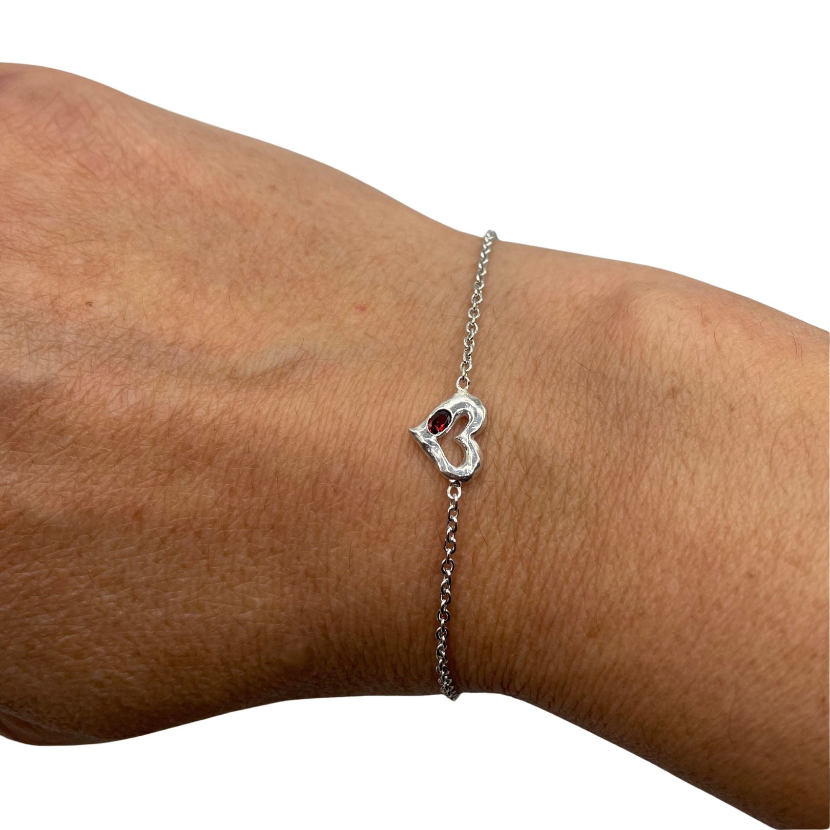 Sterling Silver Heart with red garnet bracelet by Amy Delson shown on the wrist