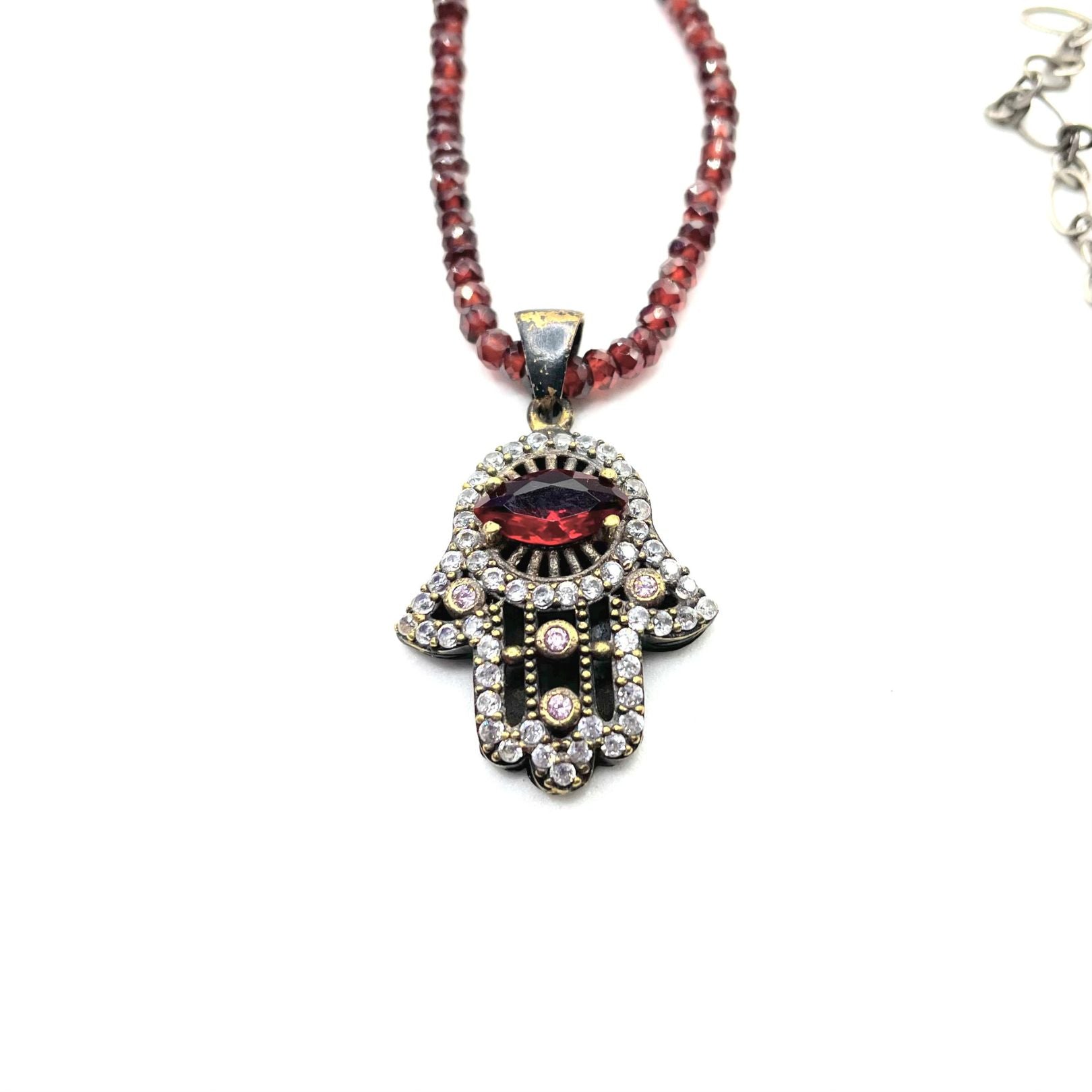 Closeup hamsa garnet necklace Amy Delson