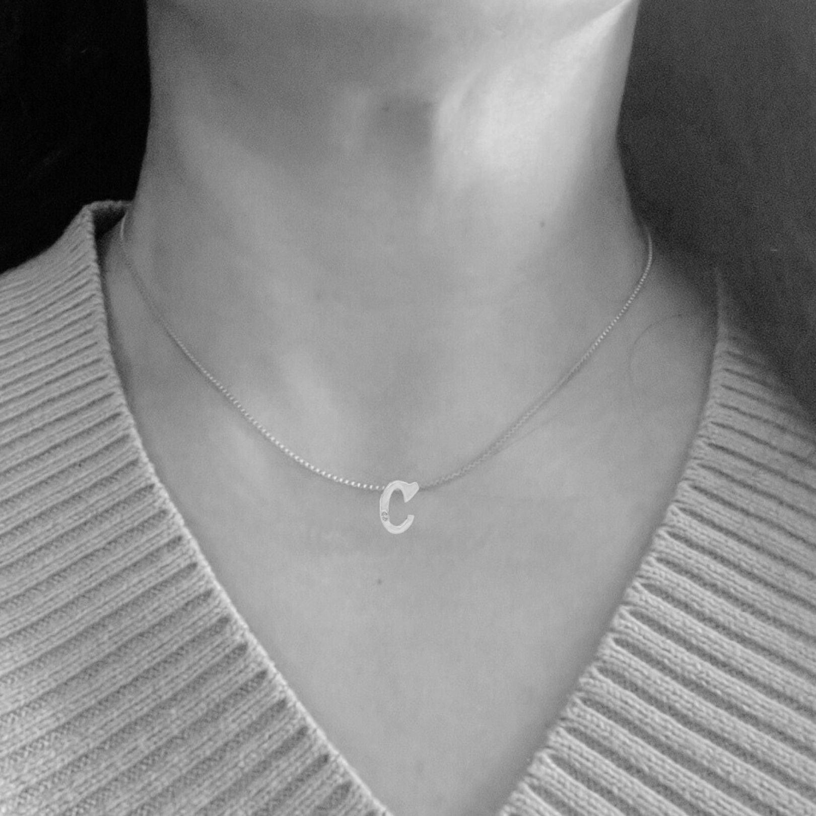 model wearing white gold C necklace with lab diamond by Amy Delson
