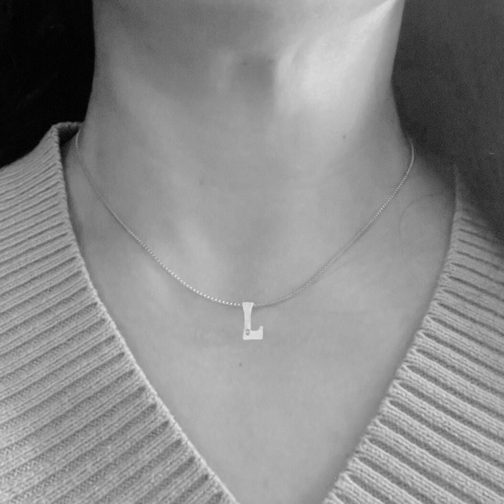 Model wearing White gold with lab diamond letter L necklace by Amy Delson