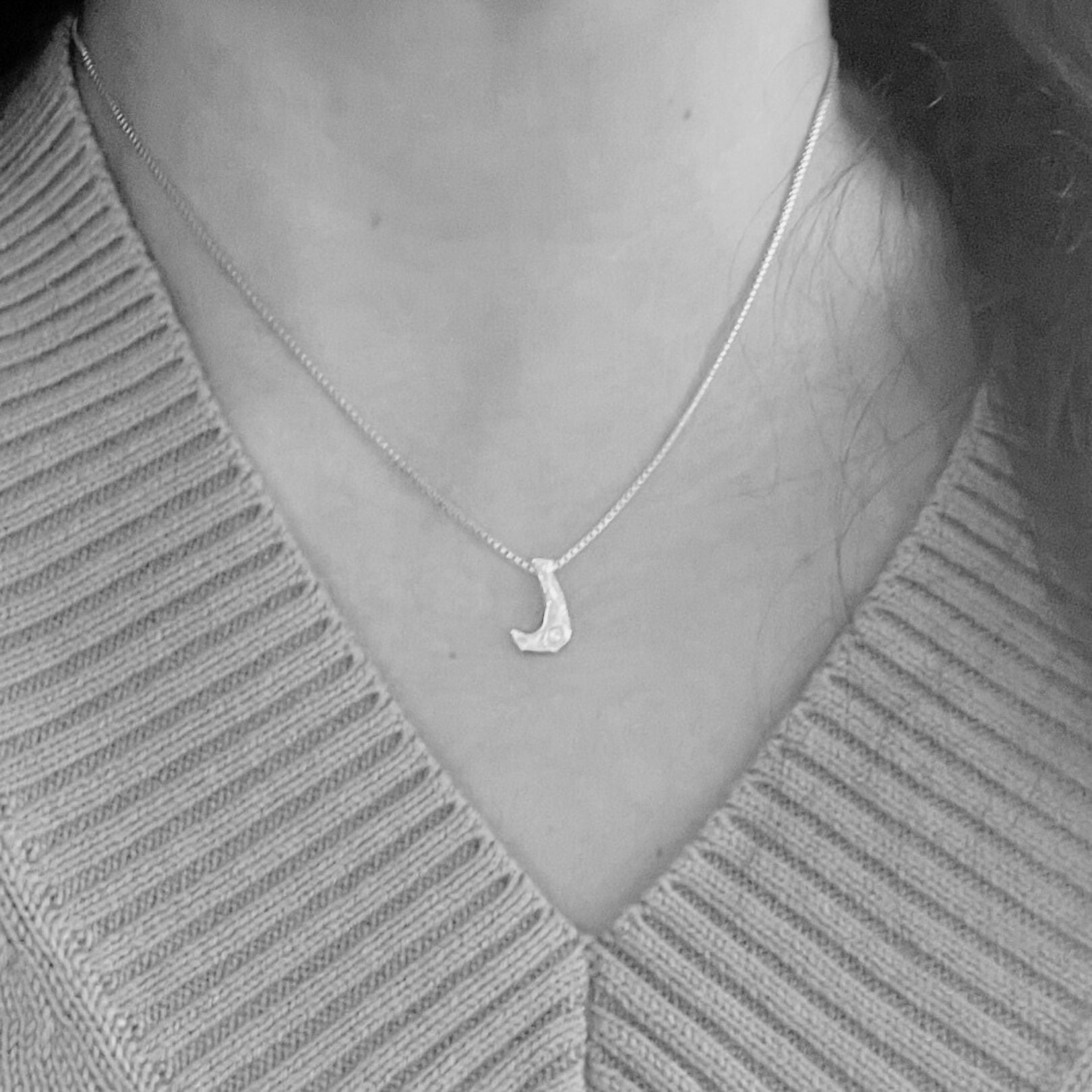 model wearing white gold with lab diamond letter J necklace by Amy Delson