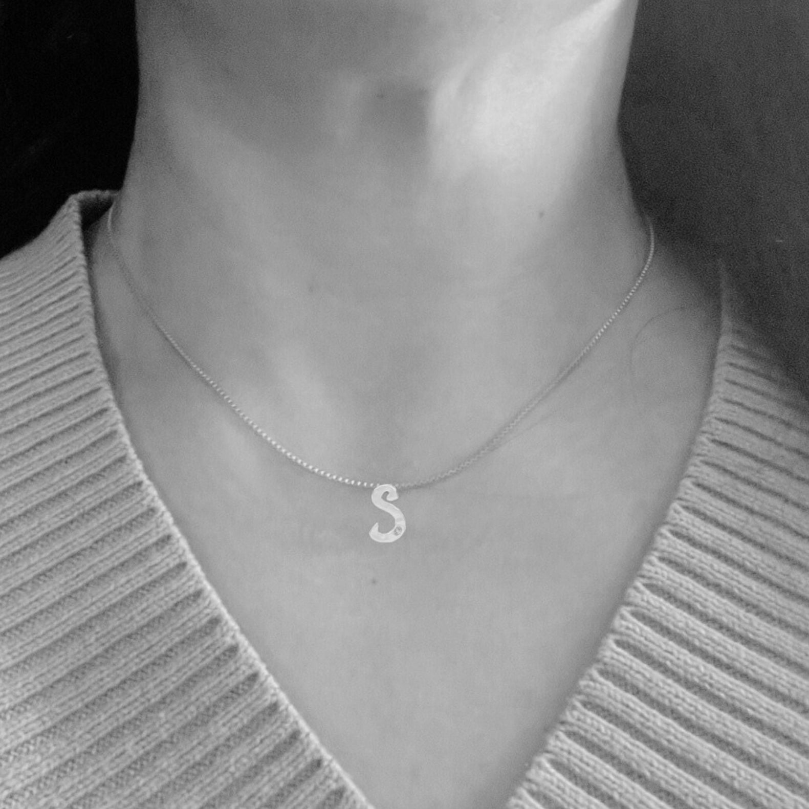 model wears white gold with lab diamond letter S necklace by Amy Delson