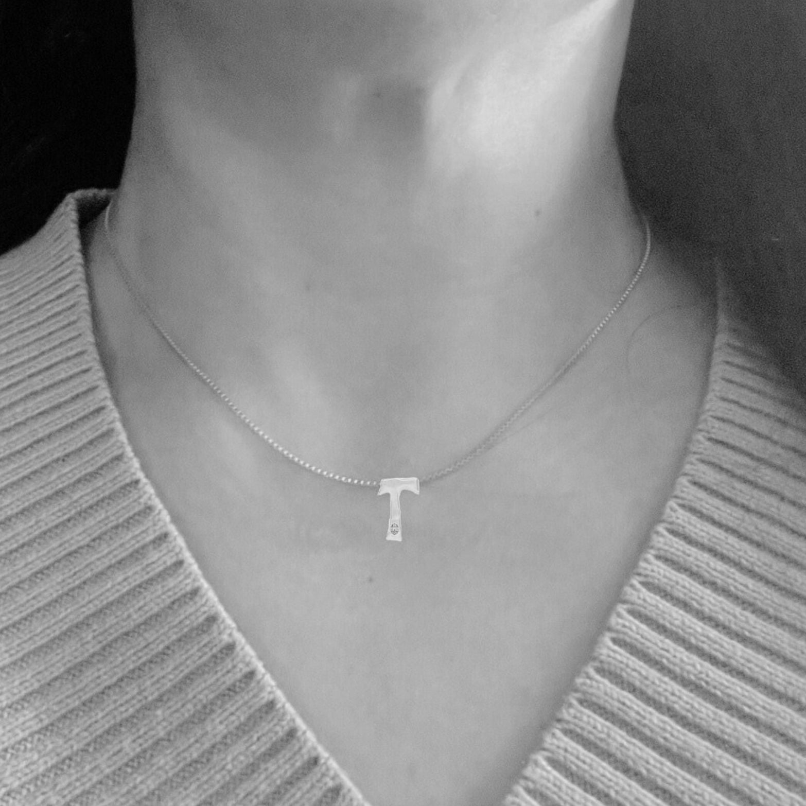 model wears white gold with lab diamond letter T necklace by Amy Delson