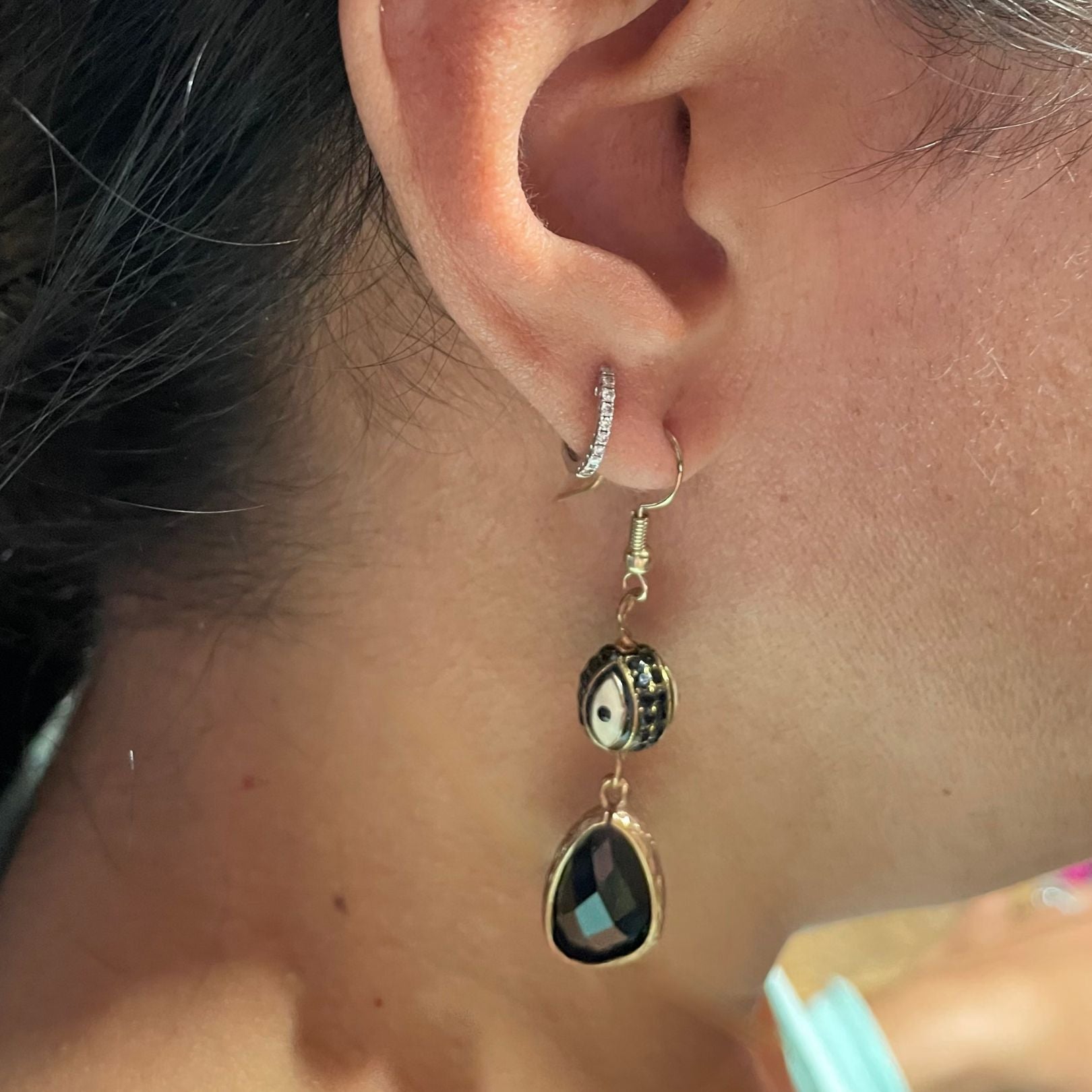 Black crystal eye earring on ear