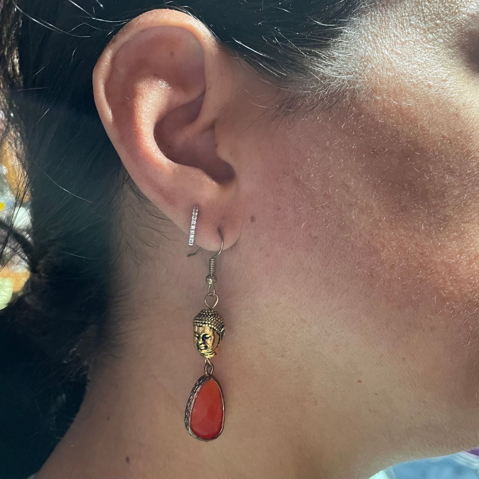 Ear with buddha dangle earring by amy delson