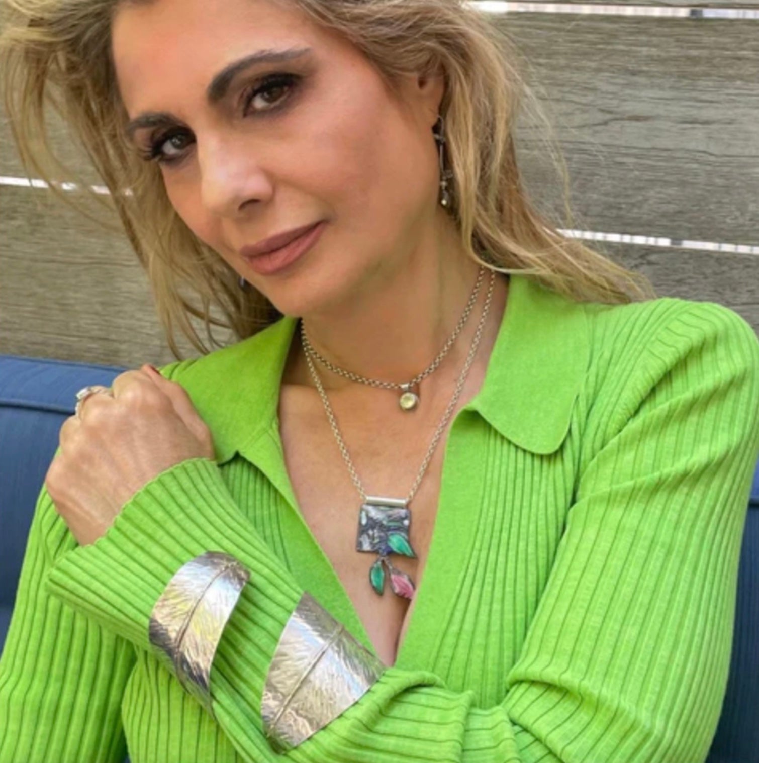 model wears Amy Delson Jewelry Feather Cuff, Enamel necklace and citrine necklace