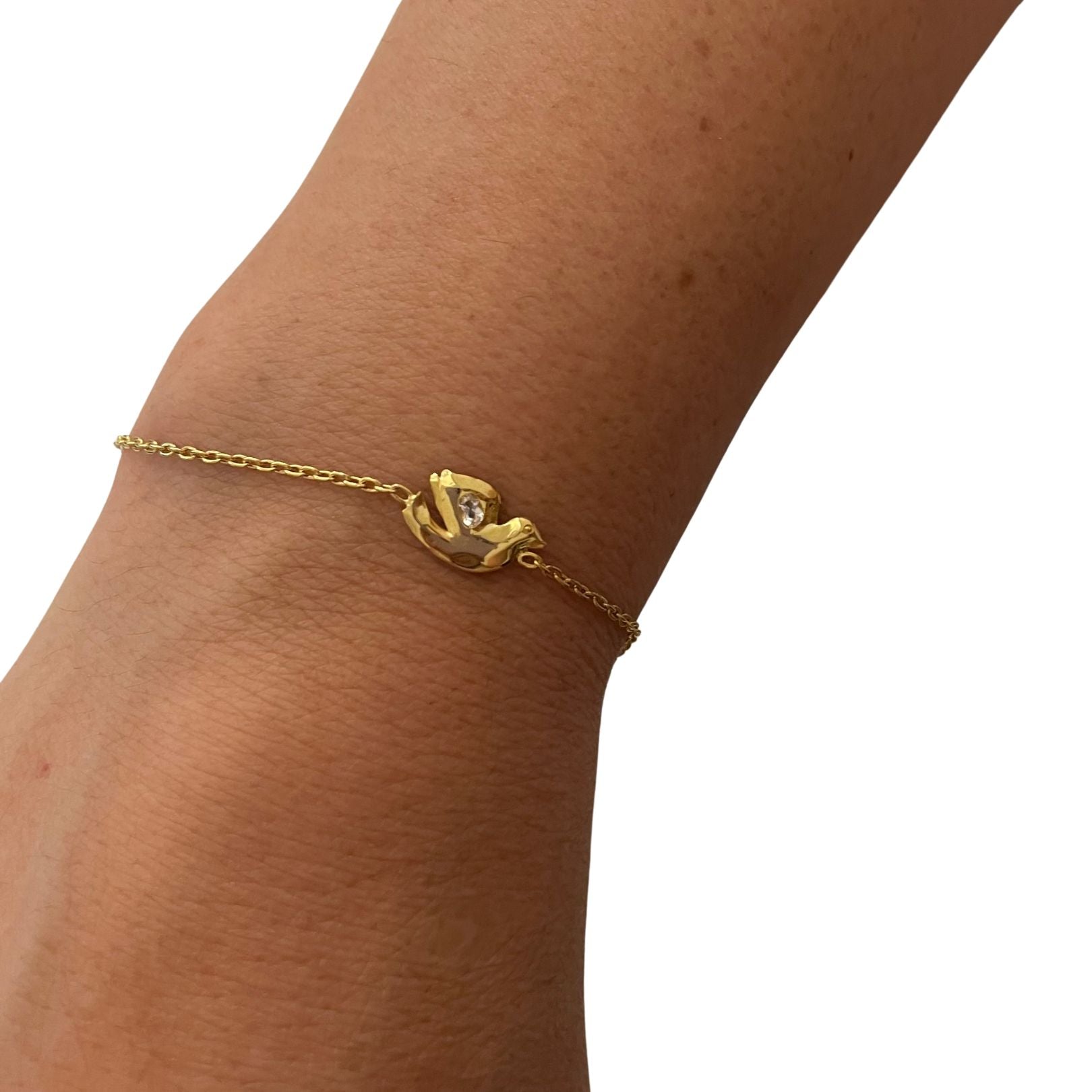 on wrist: 18k gold vermeil with white topaz dove bracelet by Amy Delson