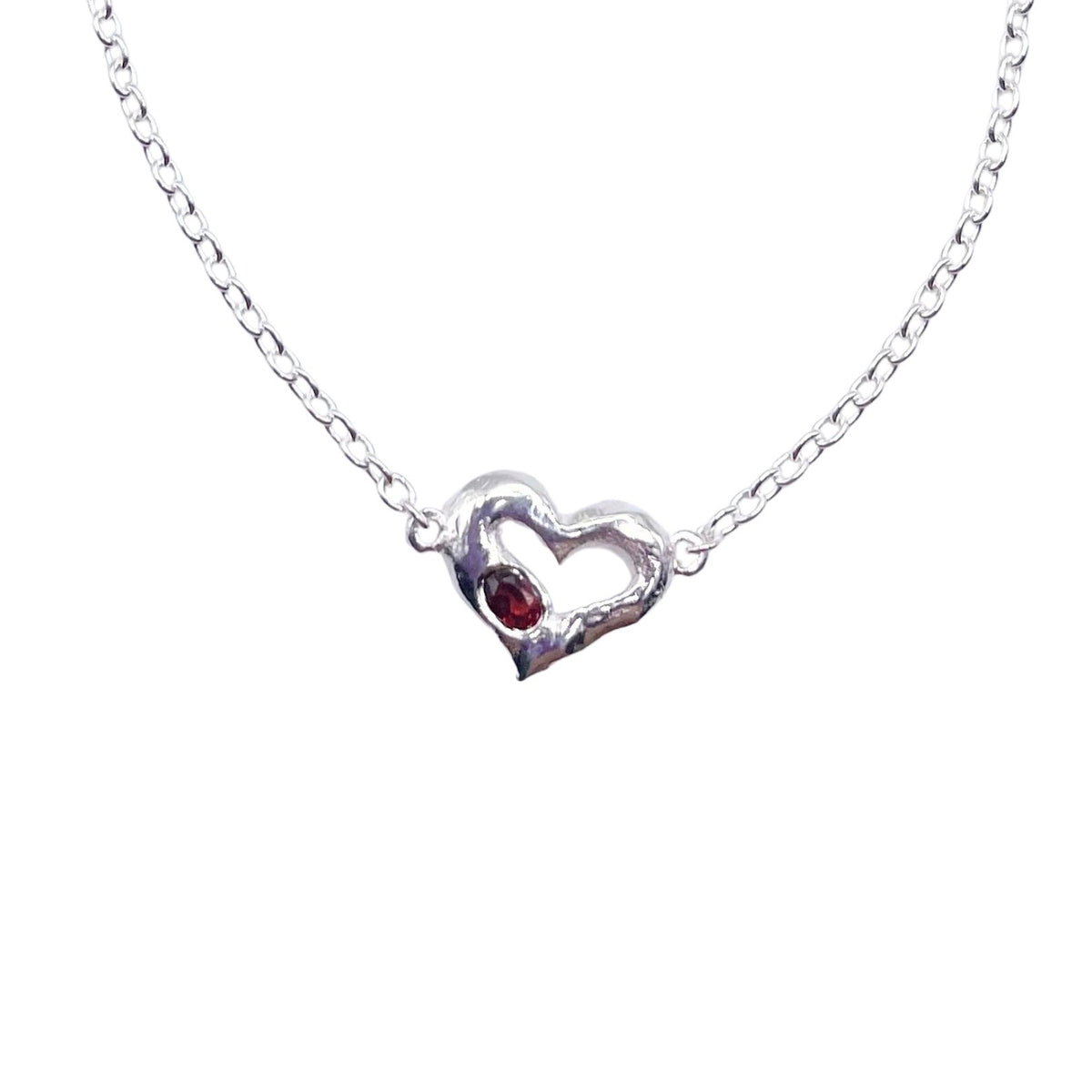 Closeup silver garnet heart bracelet by Amy Delson