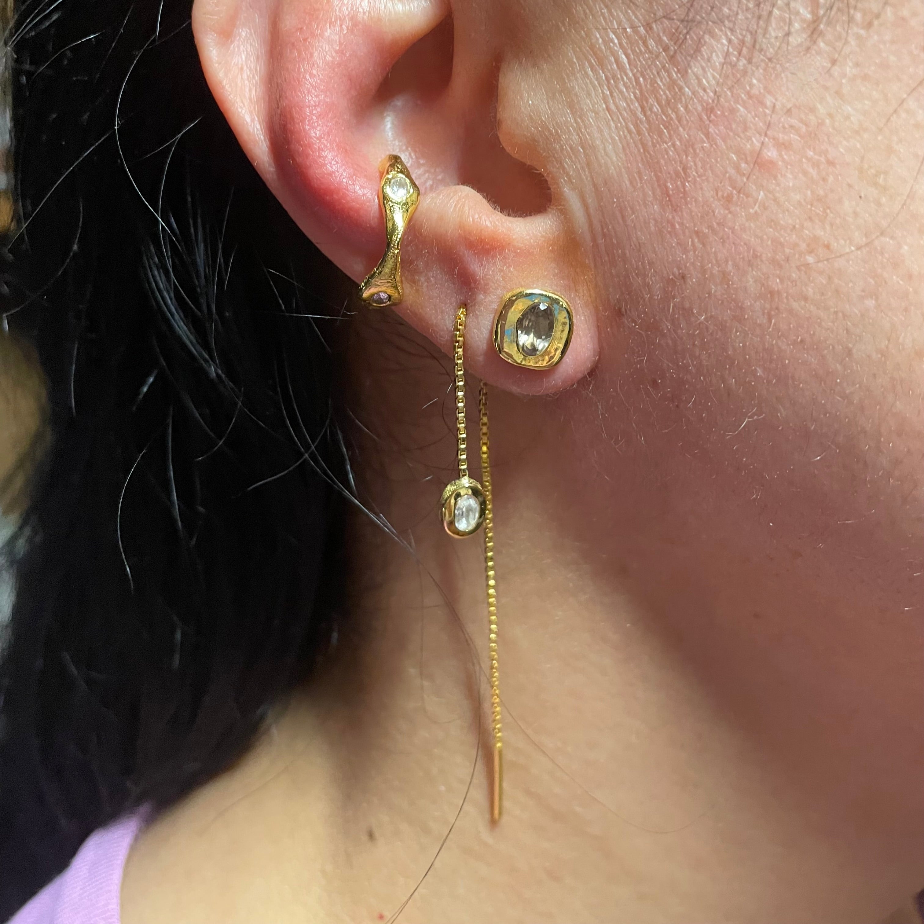 Earring stack by Amy Delson in White Topaz, Smoky quartz an gold vermeil on ear