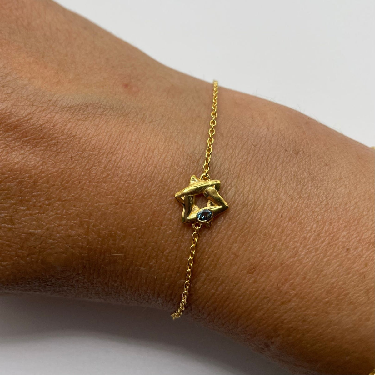 Gold Star of David bracelet by Amy Delson on wrist