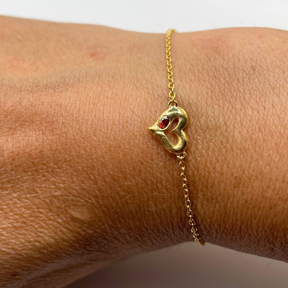 Gold garnet heart bracelet by Amy Delson