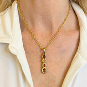 Amy Delson Garnet citrine pendant on model 