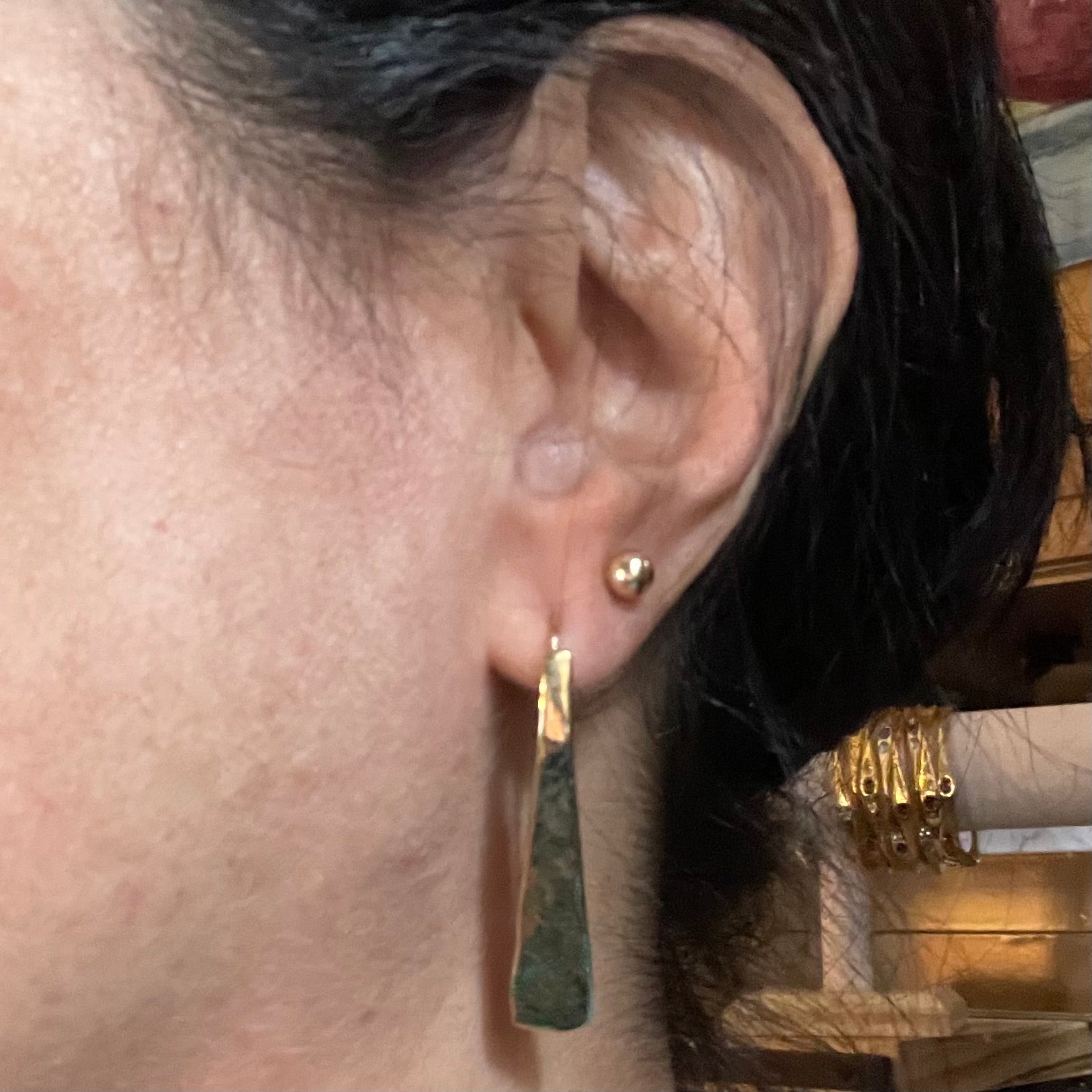 Gold Wedge earring by Amy Delson shown on ear