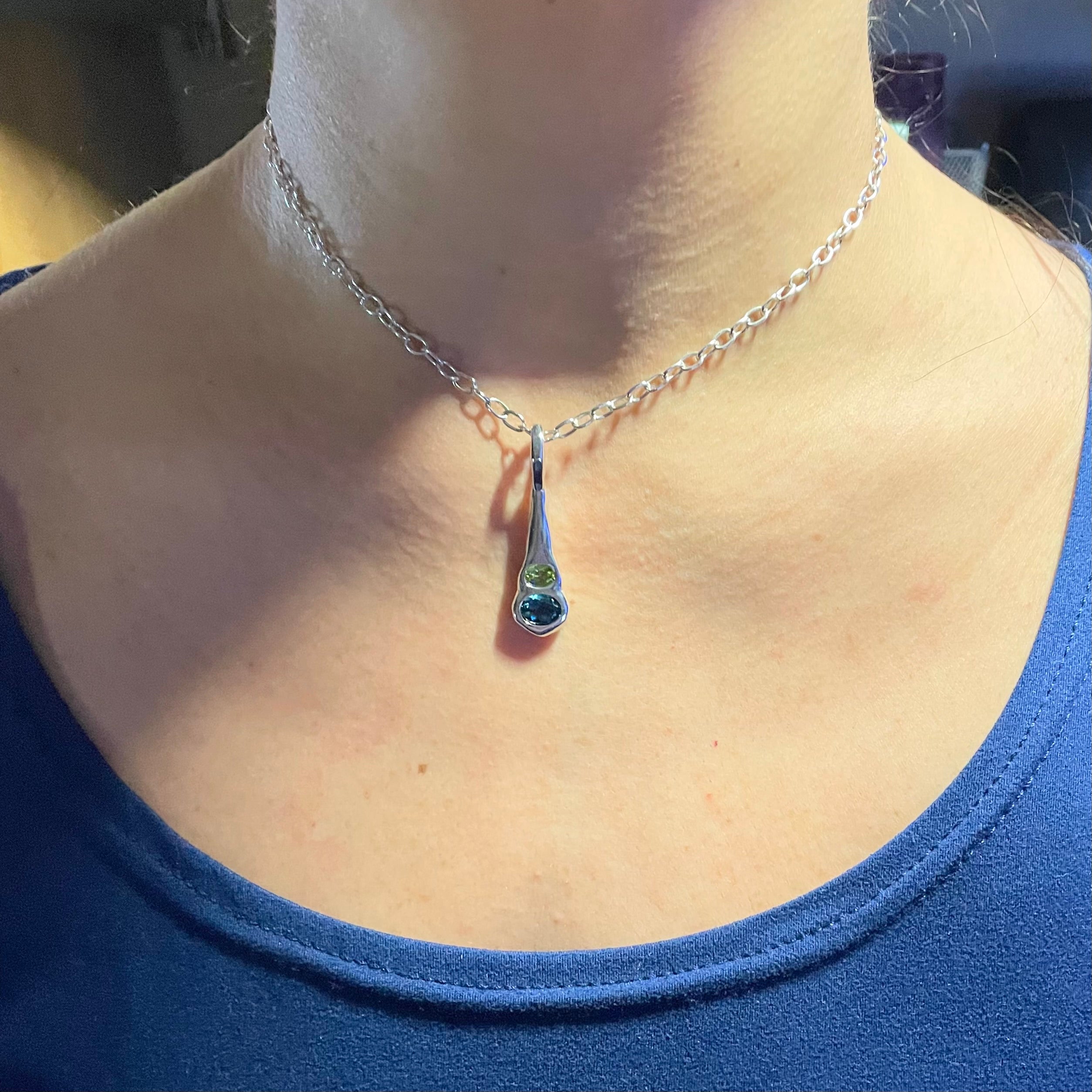 Blue topaz, green peridot sterling silver necklace shown worn