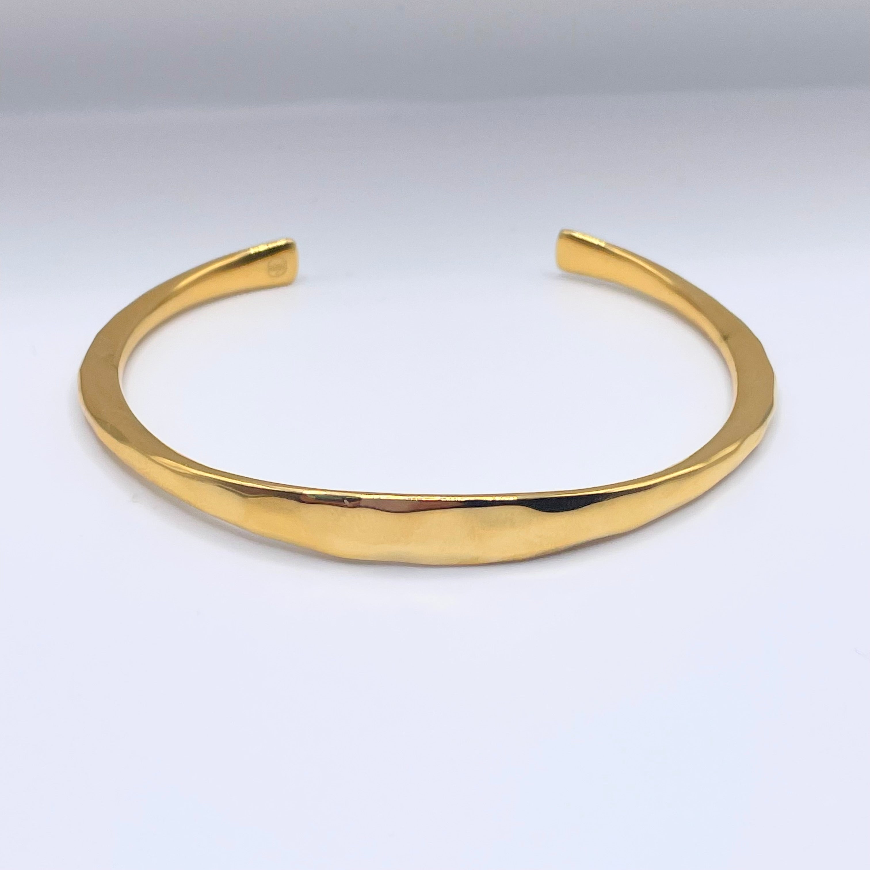 Gold forged cuff by Amy Delson