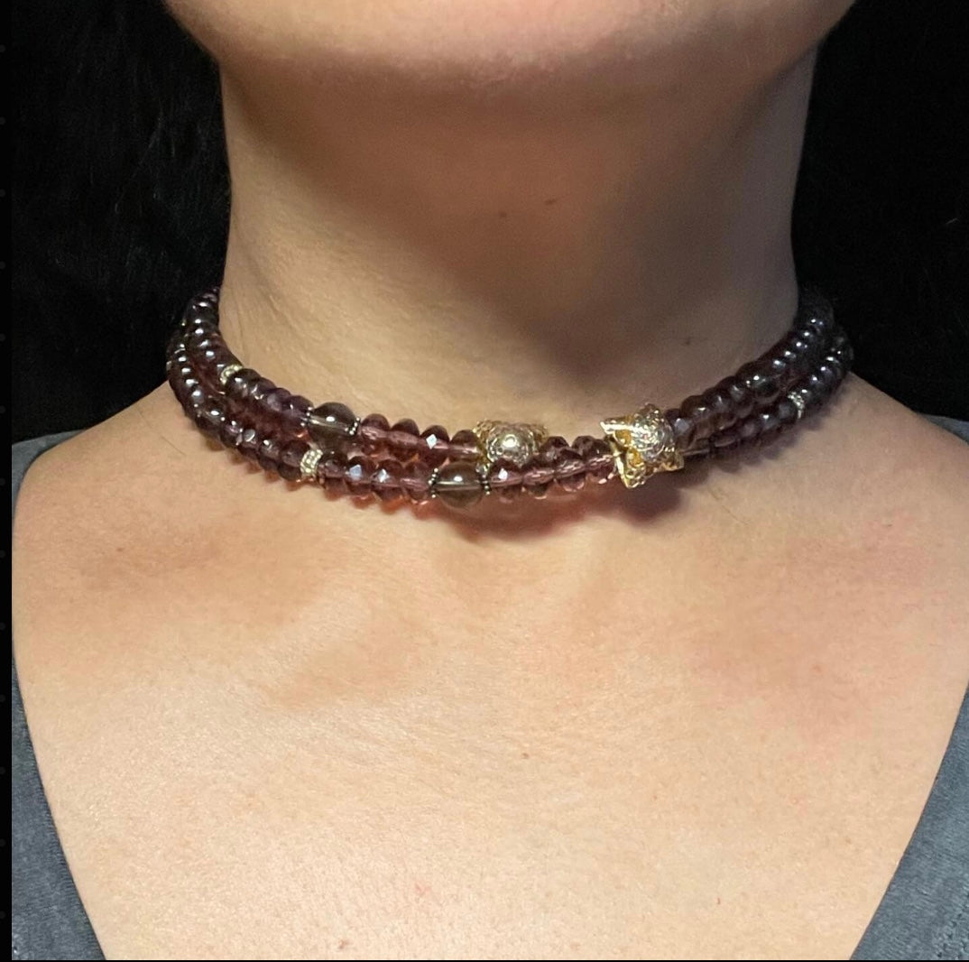 Purple beaded necklace doubled on neck