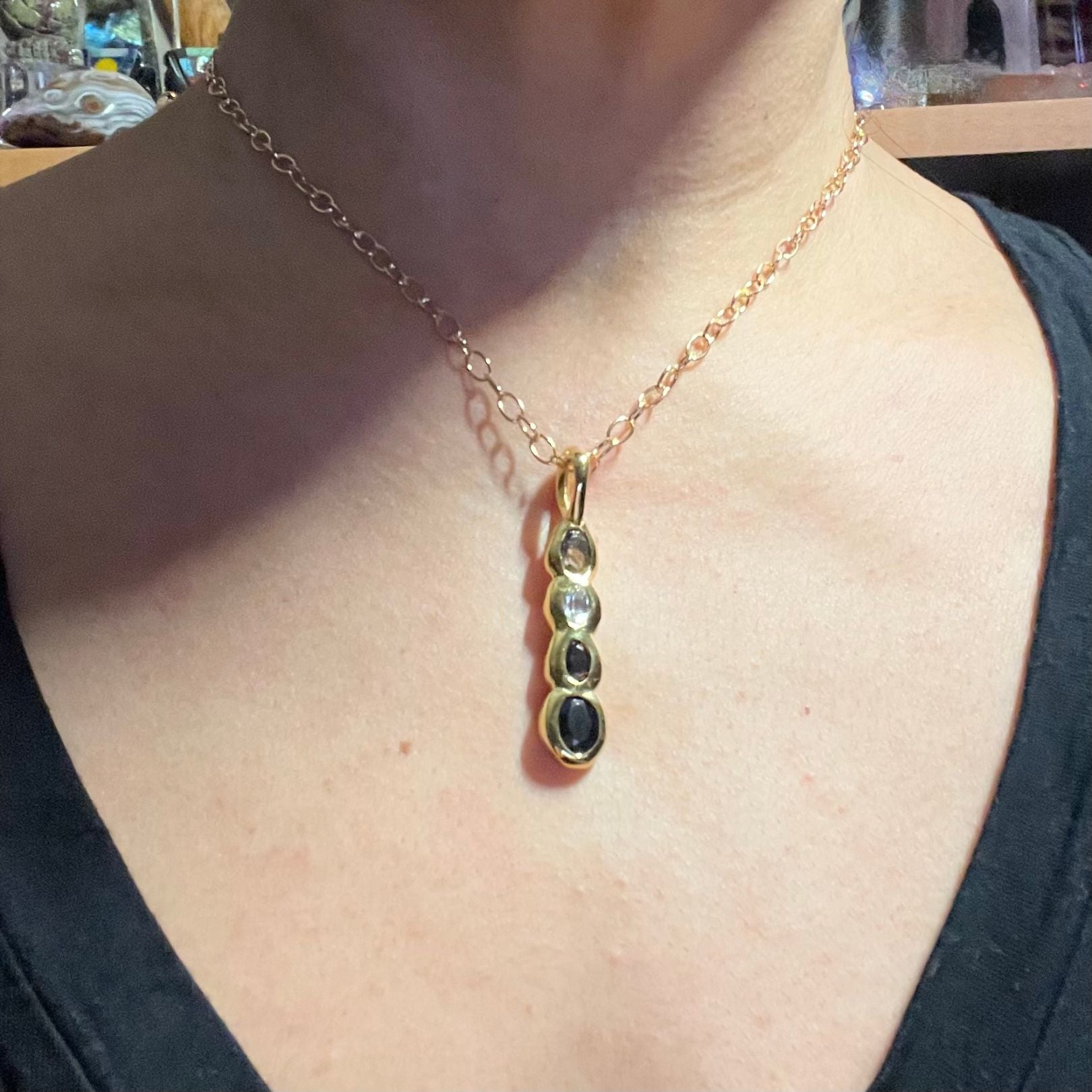 On model: Amy Delson Onyx White Topaz Smoky Quartz Olivia Pendant Necklace in Gold