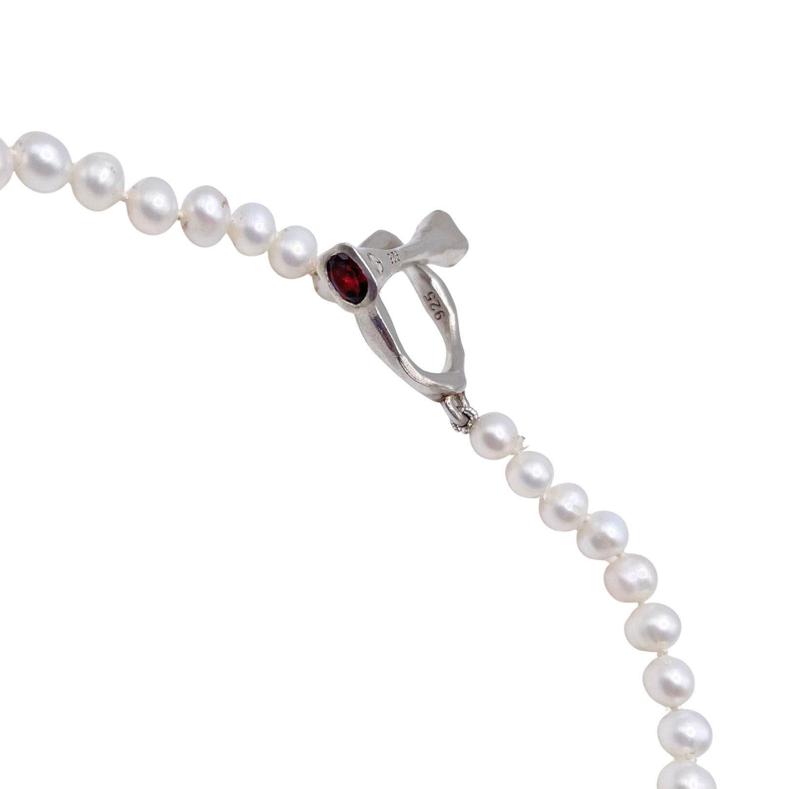 Pearl necklace with a silver clasp featuring a red gemstone by Amy Delson