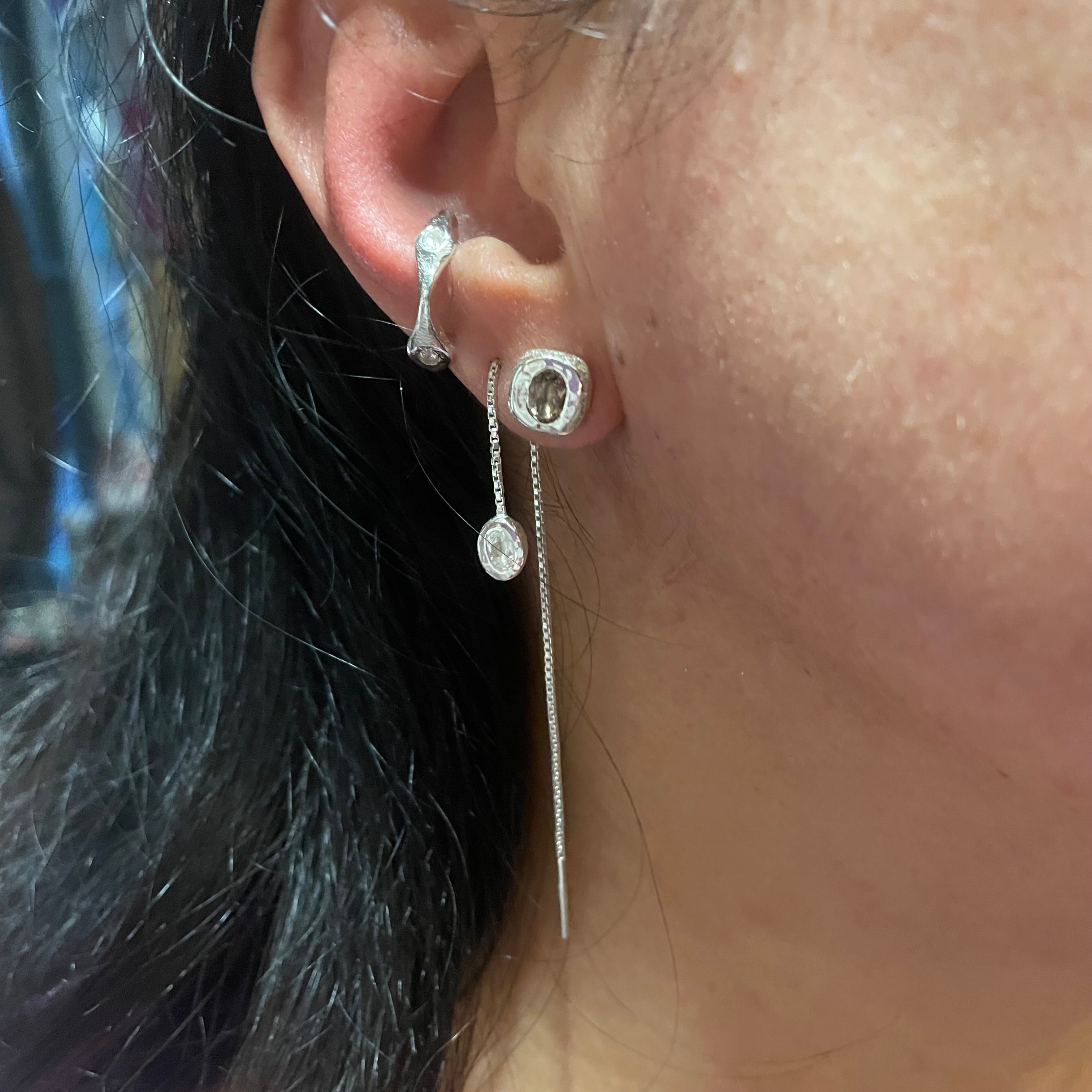 Sterling Silver white topaz and smoky quartz earring trio by Amy Delson shown on ear