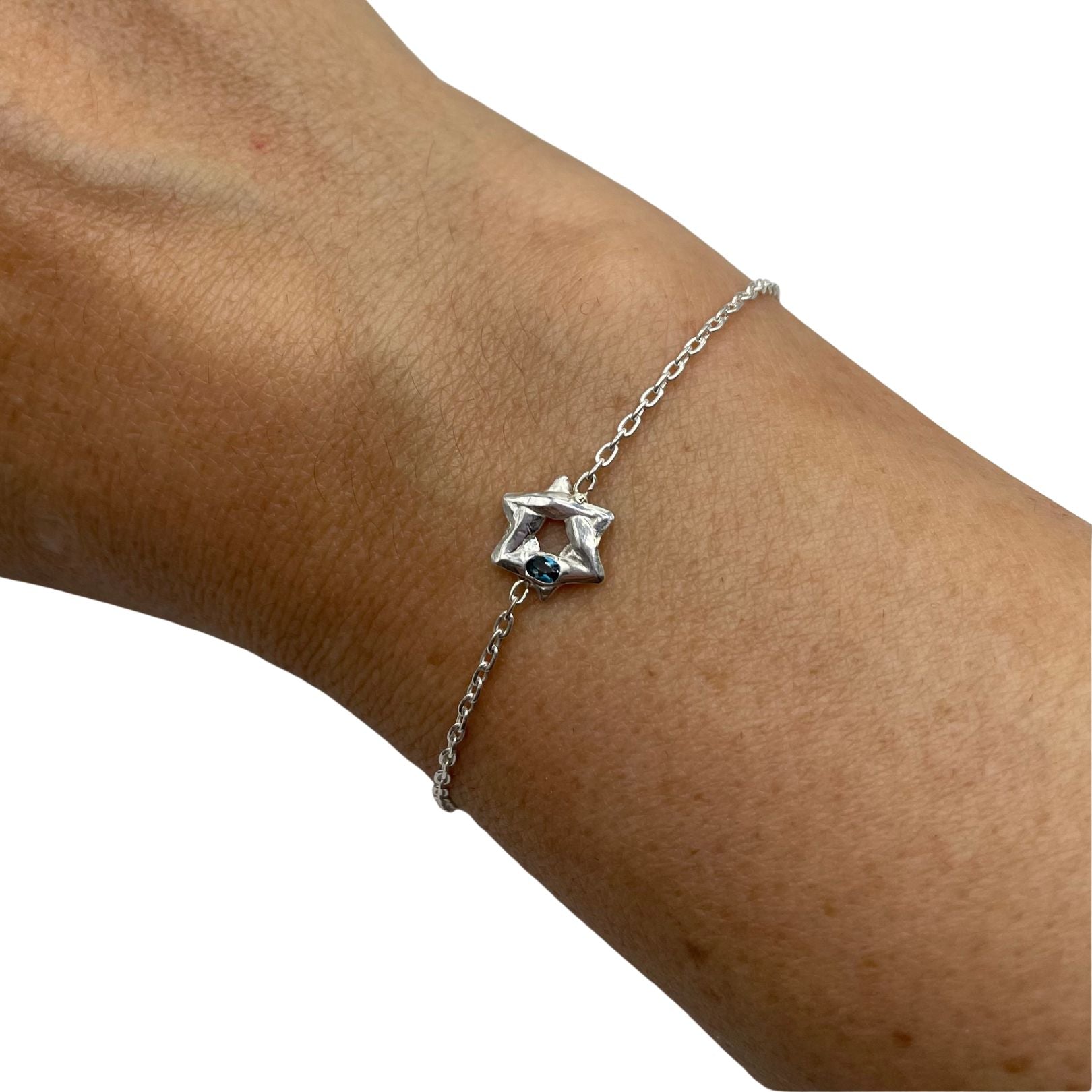 Sterling silver Star of David bracelet with London blue topaz by Amy Delson on wrist