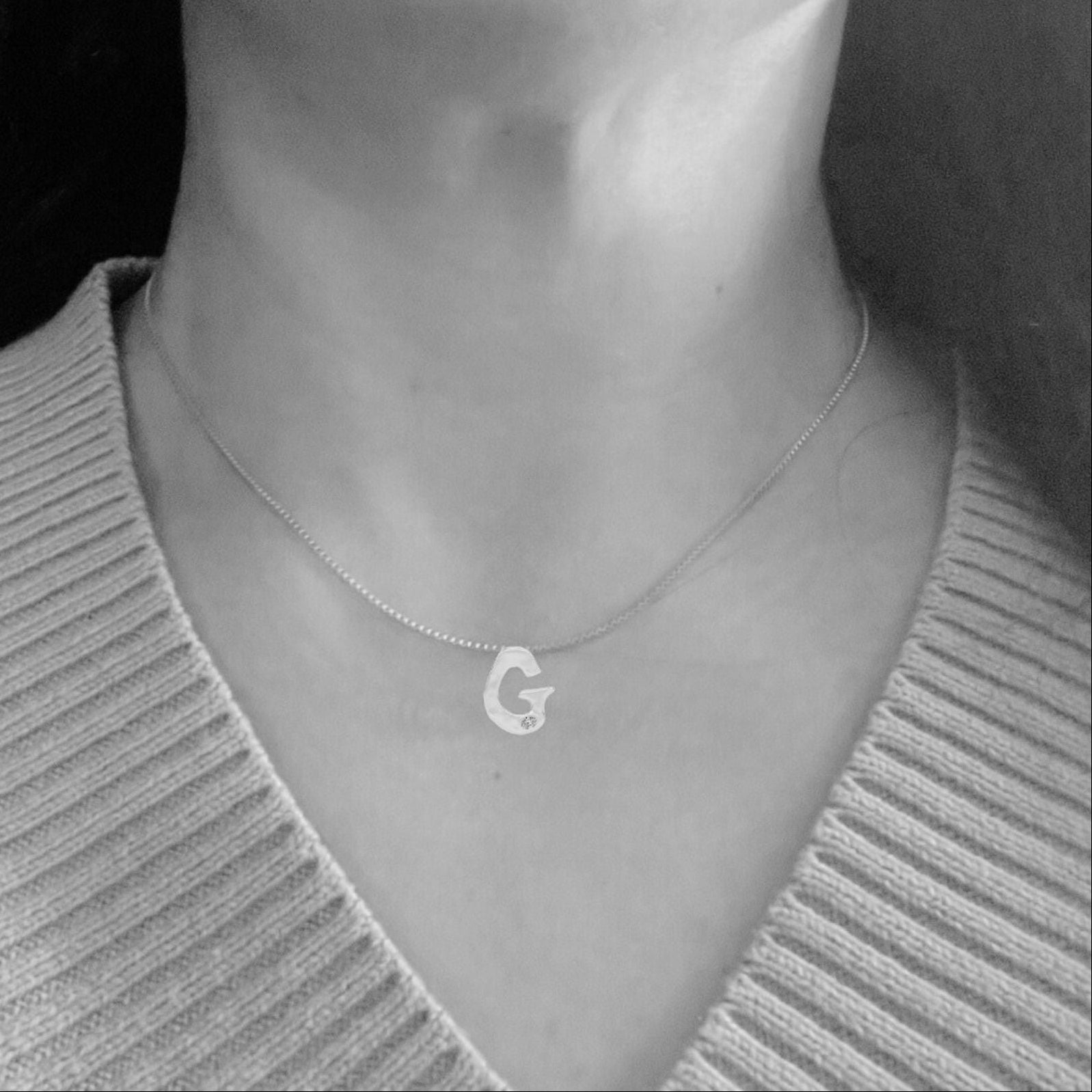 model wearing white gold with lab diamond letter G necklace by Amy Delson