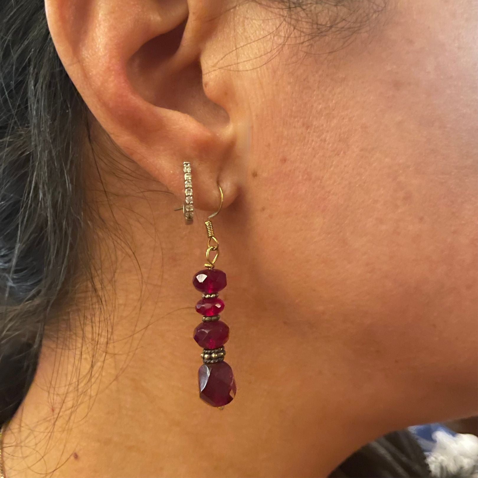 Red beaded earring shown on ear