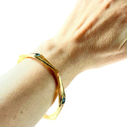 Gold Blue Topaz bangle on wrist