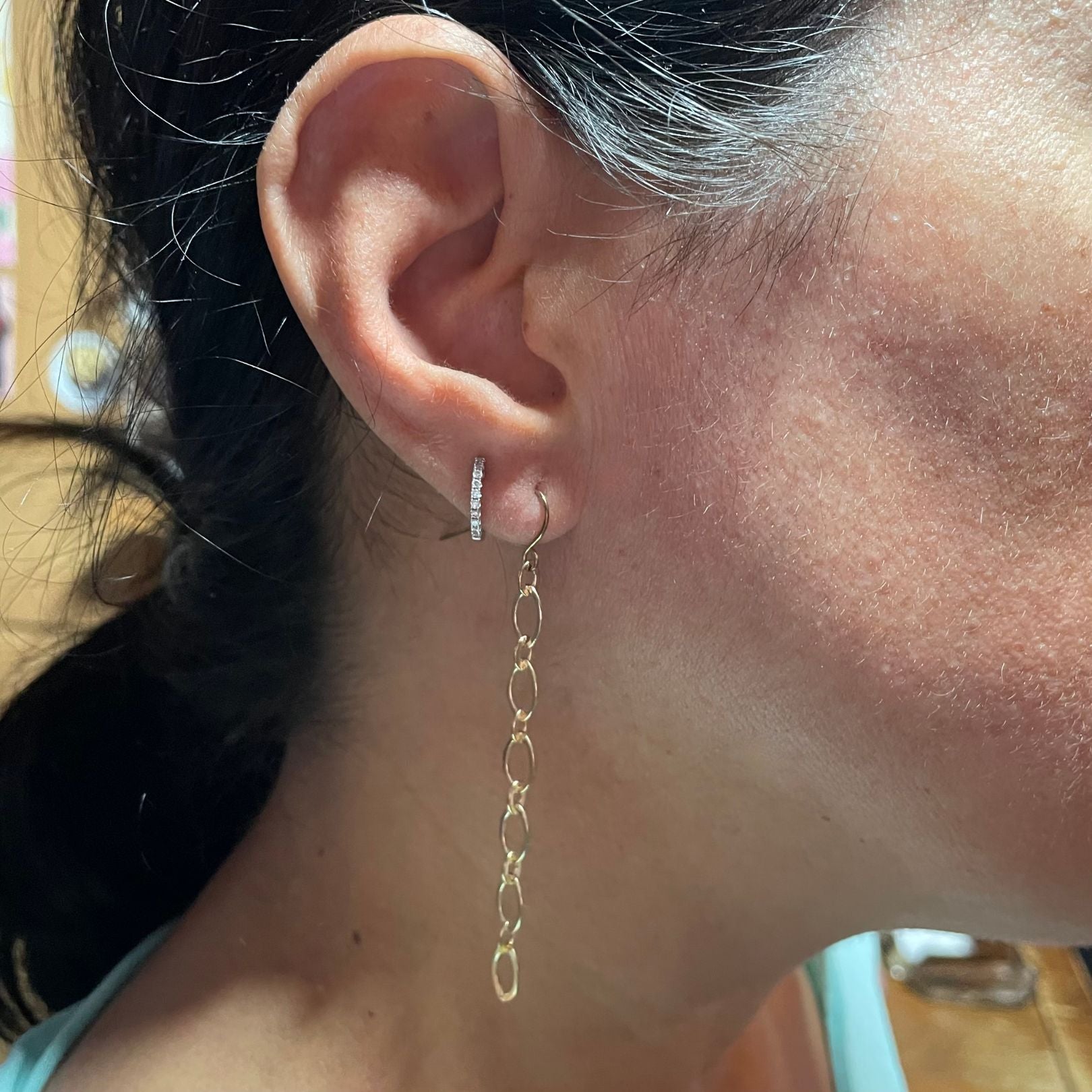 Gold chain earring by Amy Delson on ear