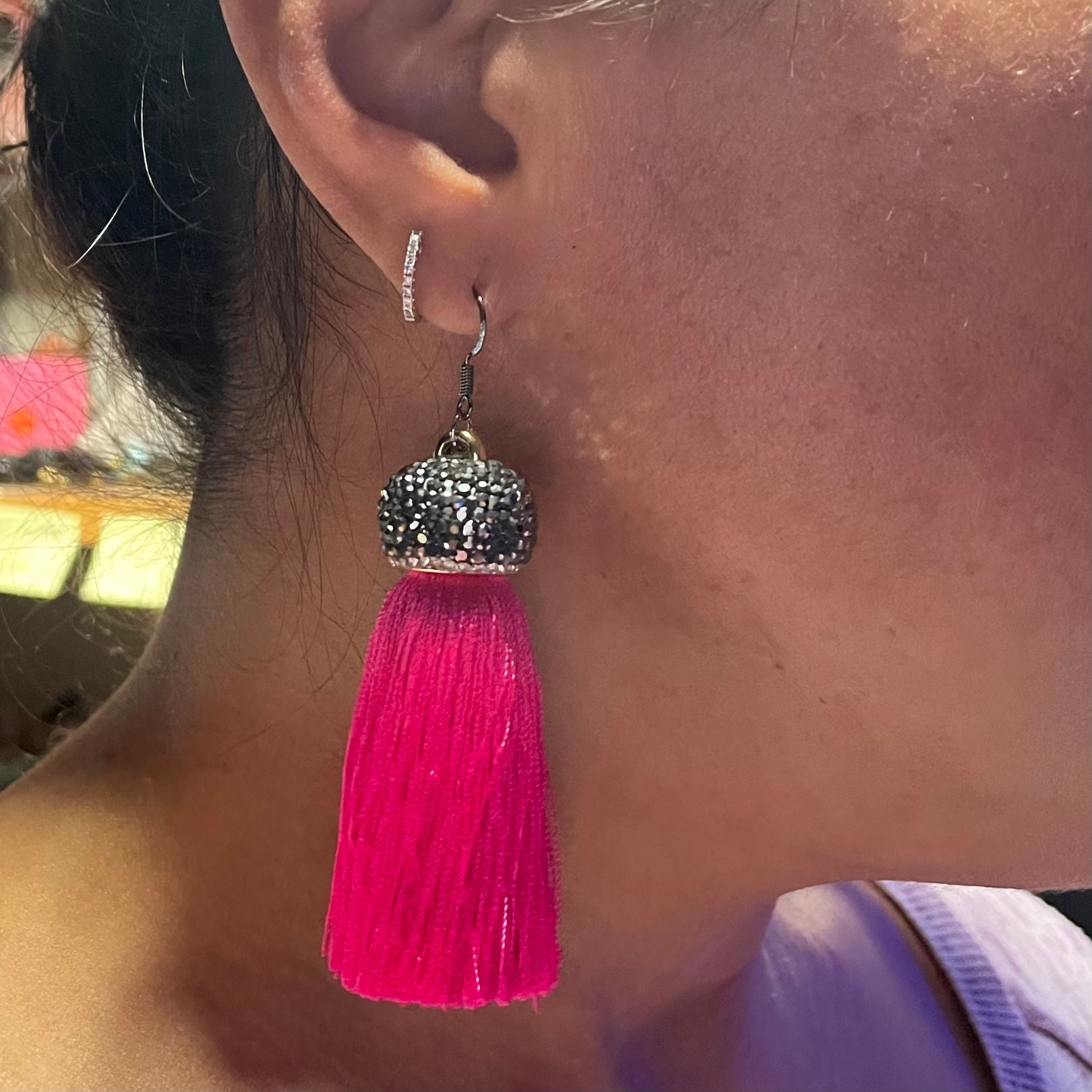 Shown on the ear  Amy Delson pink tassel earring