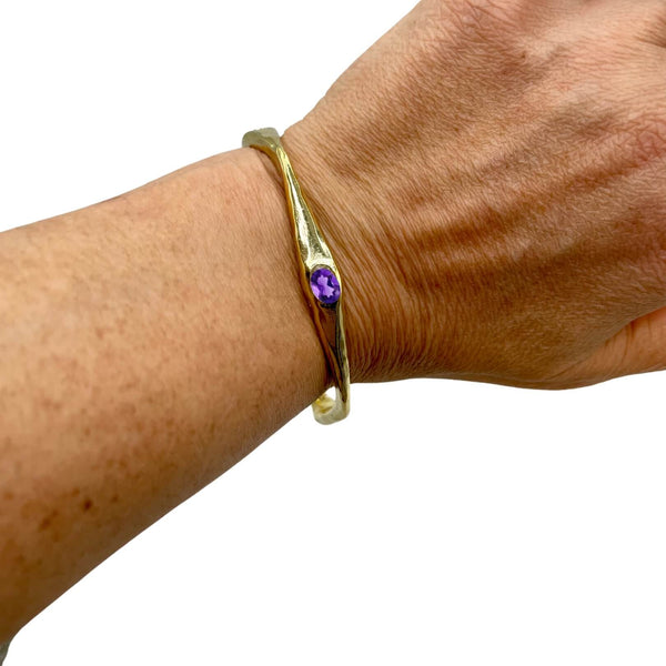 Amy Delson amethyst gold bangle on wrist
